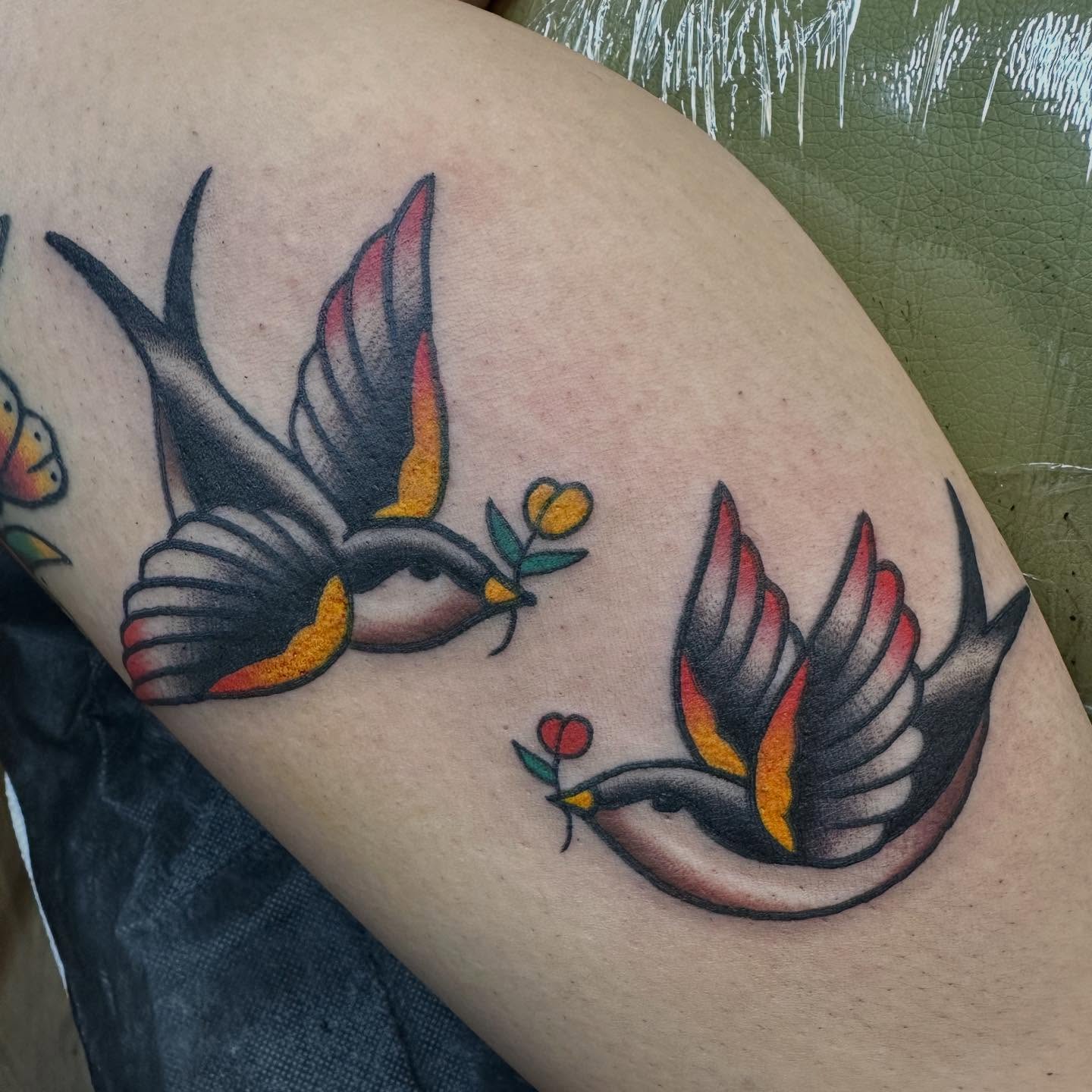 Swallows and flowers American traditional tattoo on the thigh by Hannah Jean
