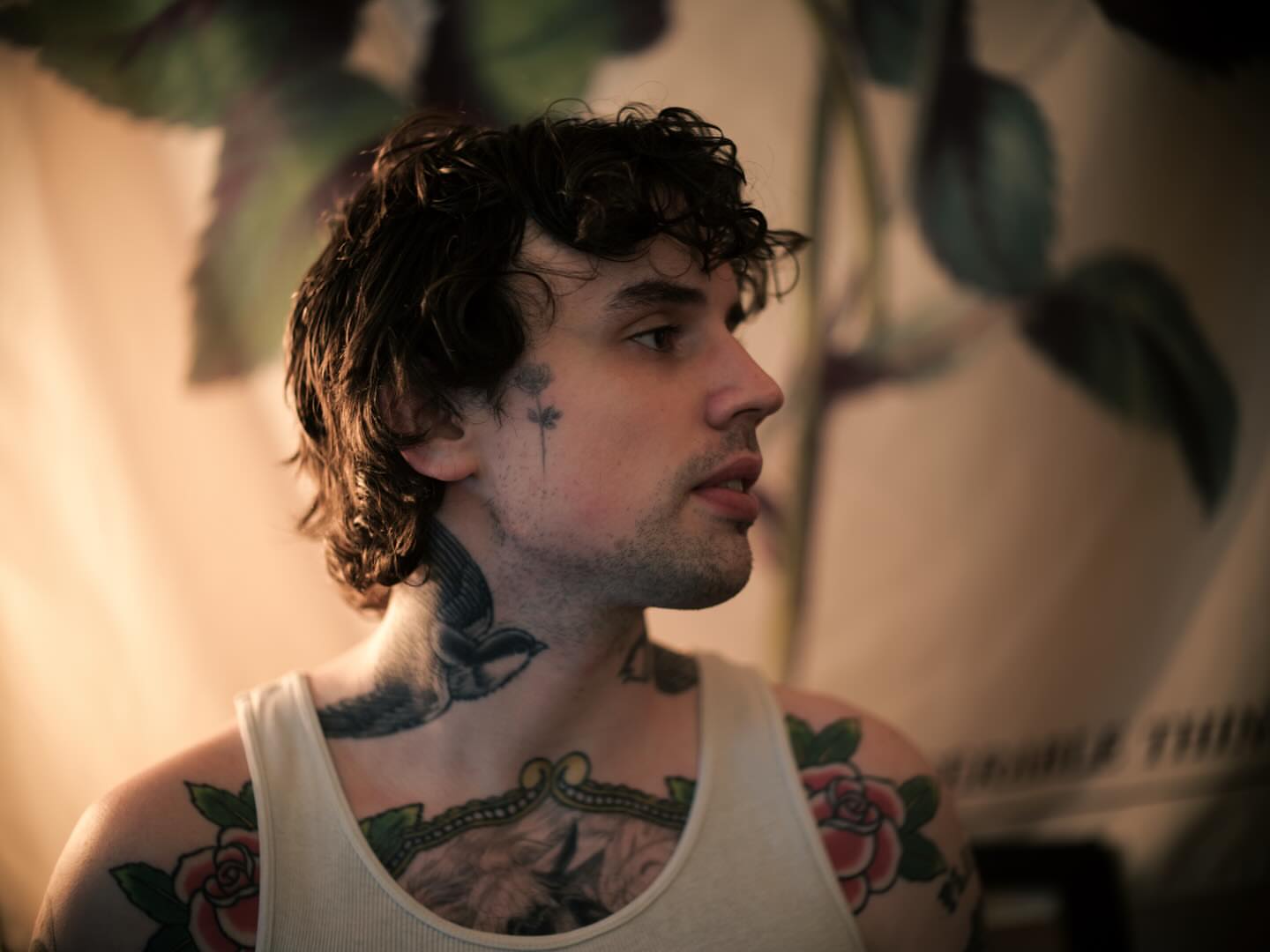 Bird and floral American traditional tattoo on the chest by Dylan Coverdale