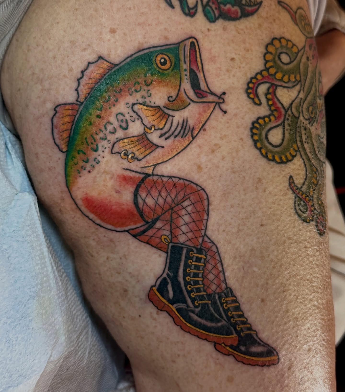 Fish and boot American traditional tattoo on the thigh by Hayley Hendrick