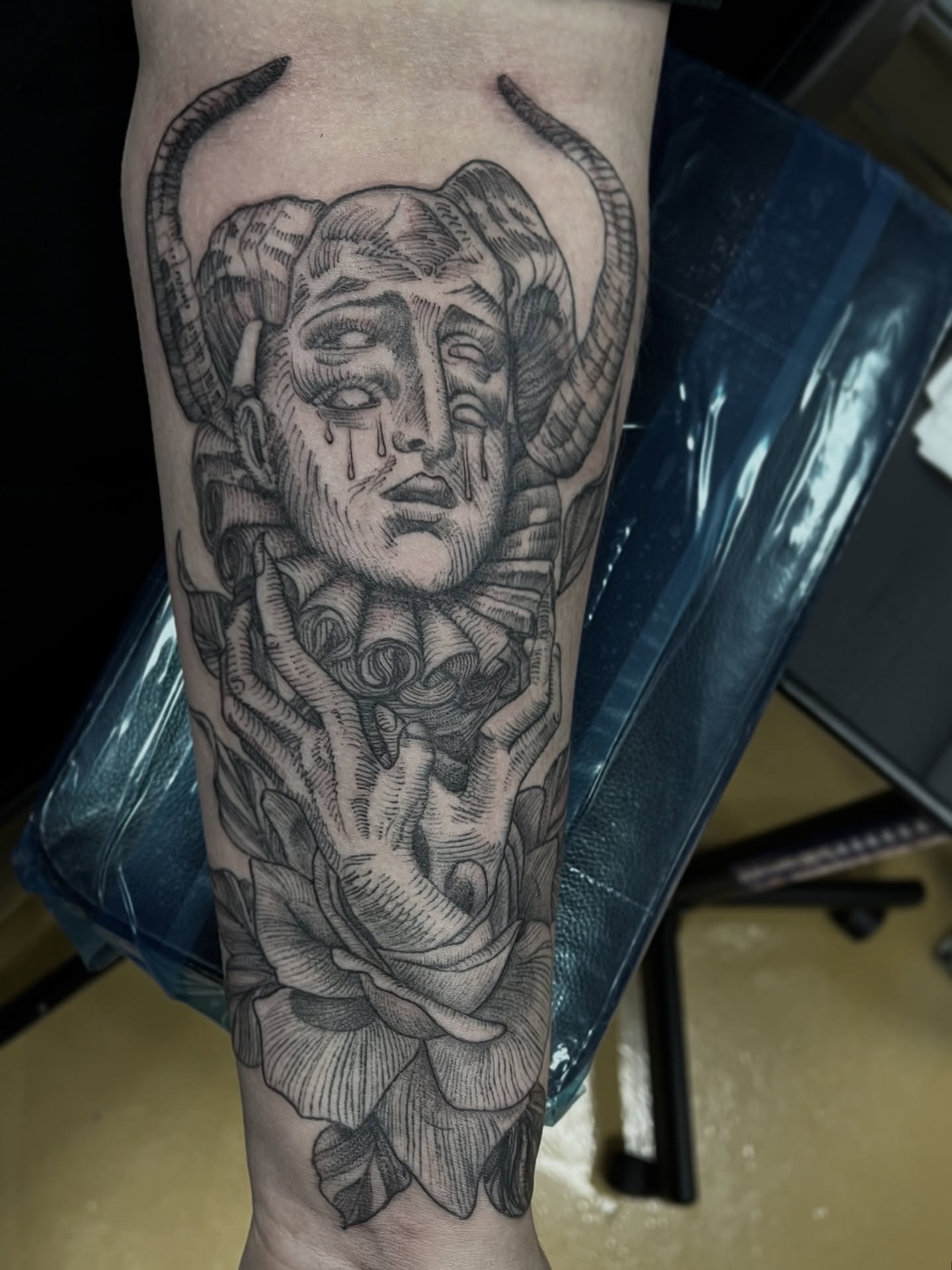 Woman's face with horns realism tattoo on the forearm by Kat