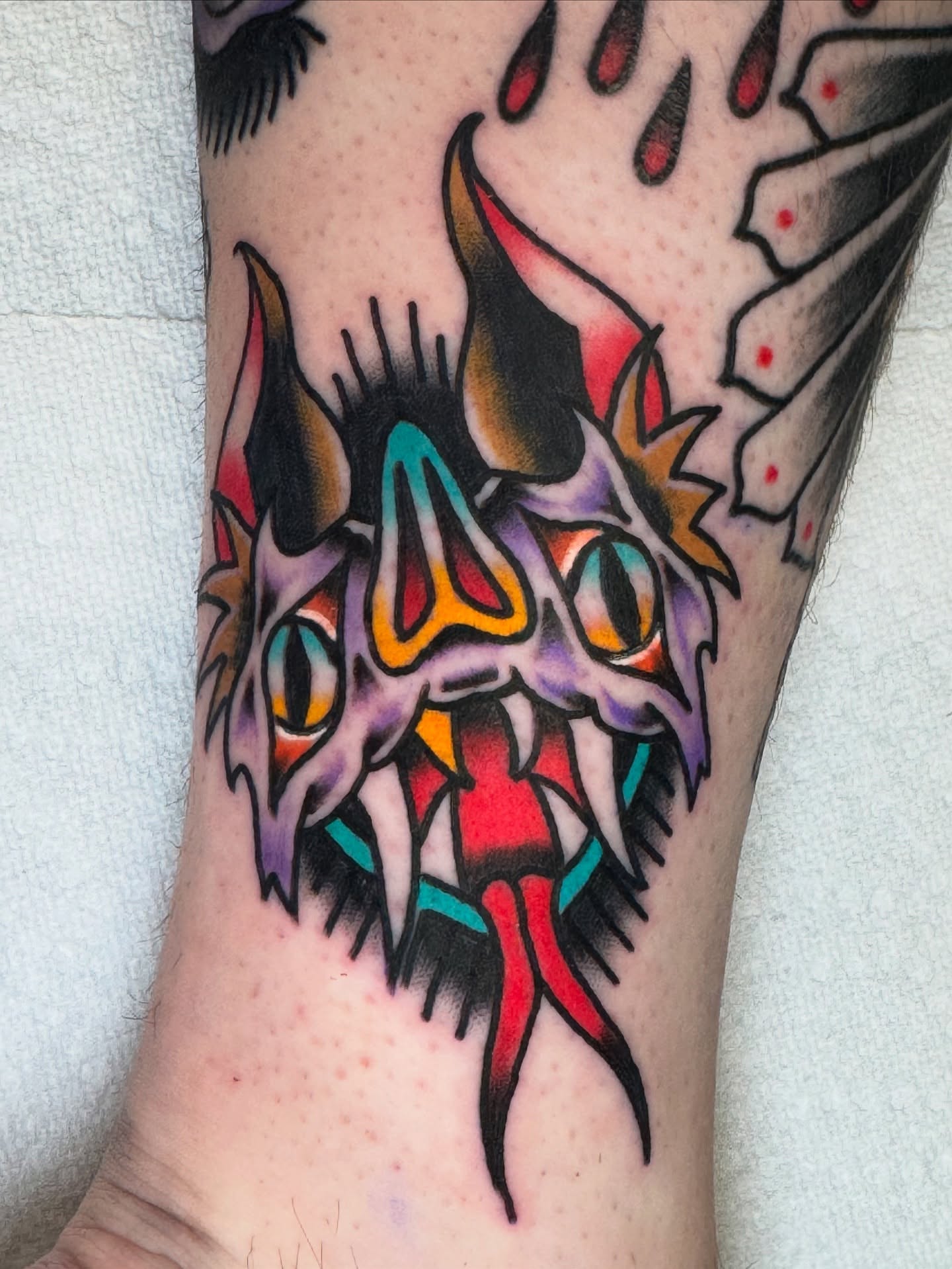 Demon skull American traditional tattoo on the forearm by Kenneth Gibson