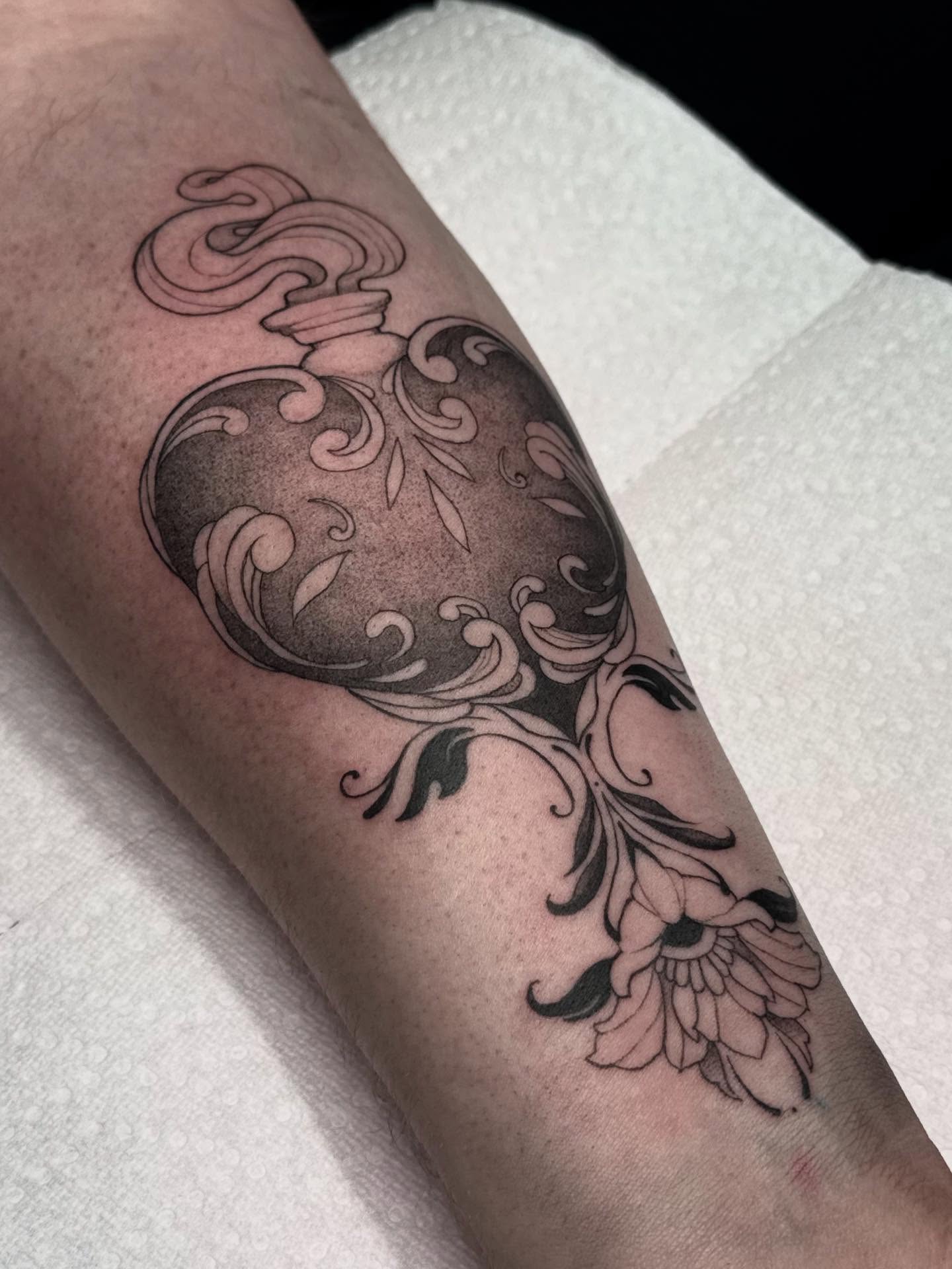 Floral heart black and grey tattoo on the forearm by Nat🫧