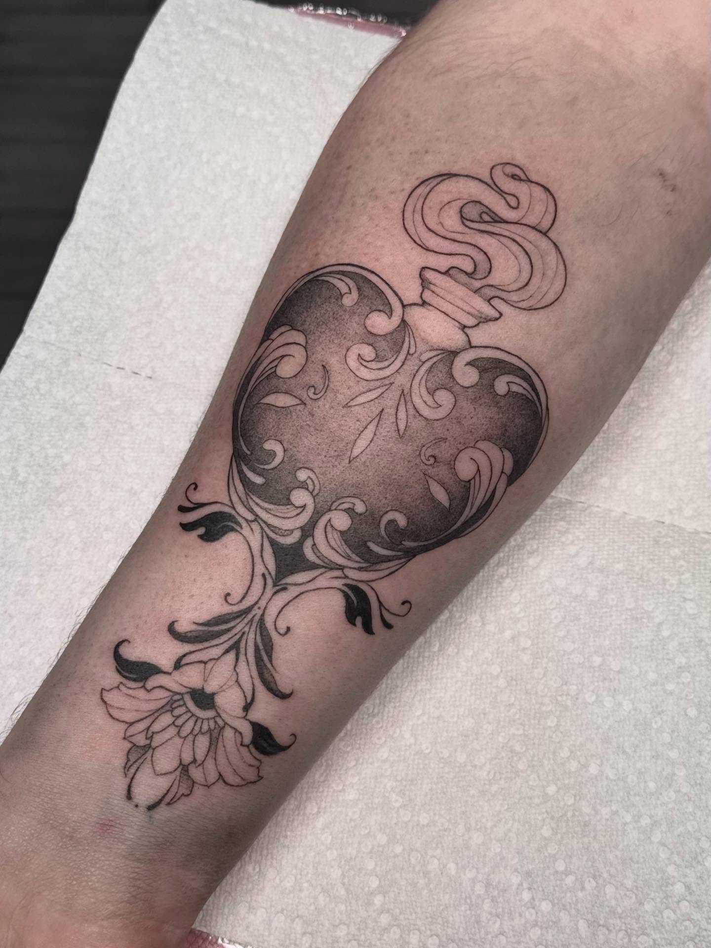 Floral heart black and grey tattoo on the forearm by Nat🫧
