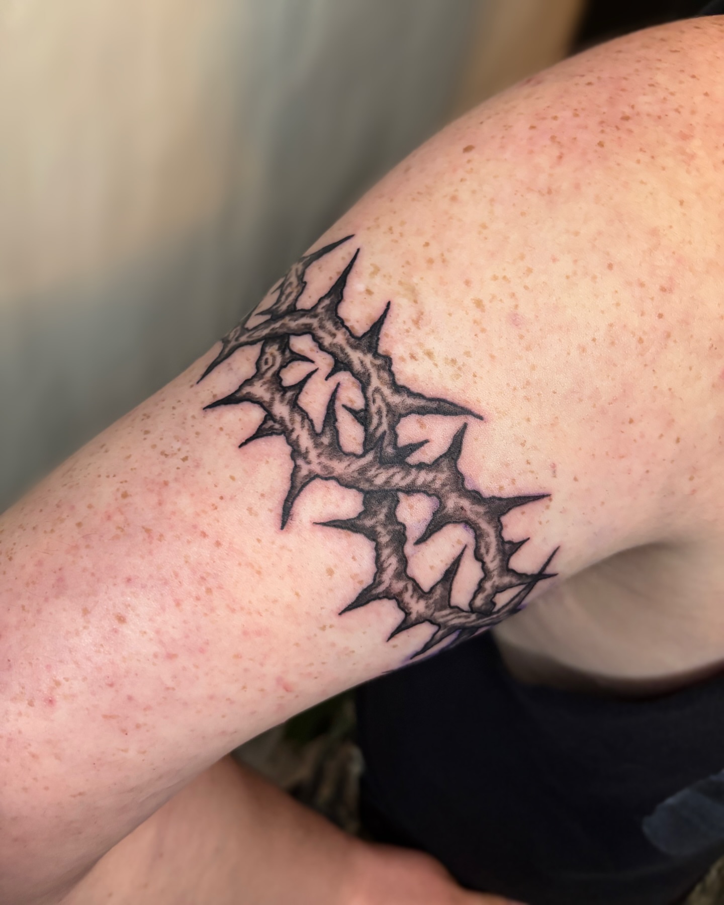 Thorn crown black and grey tattoo on the forearm by Cooper, Portland, Oregon