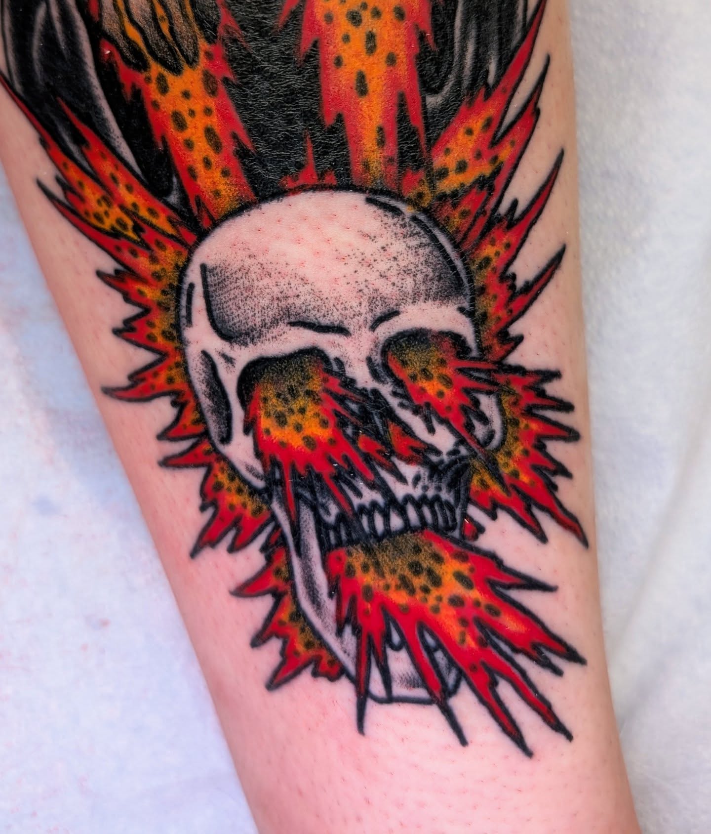 Skull with flames dotwork tattoo on the forearm by Erik O'Steen, Medford, Massachusetts