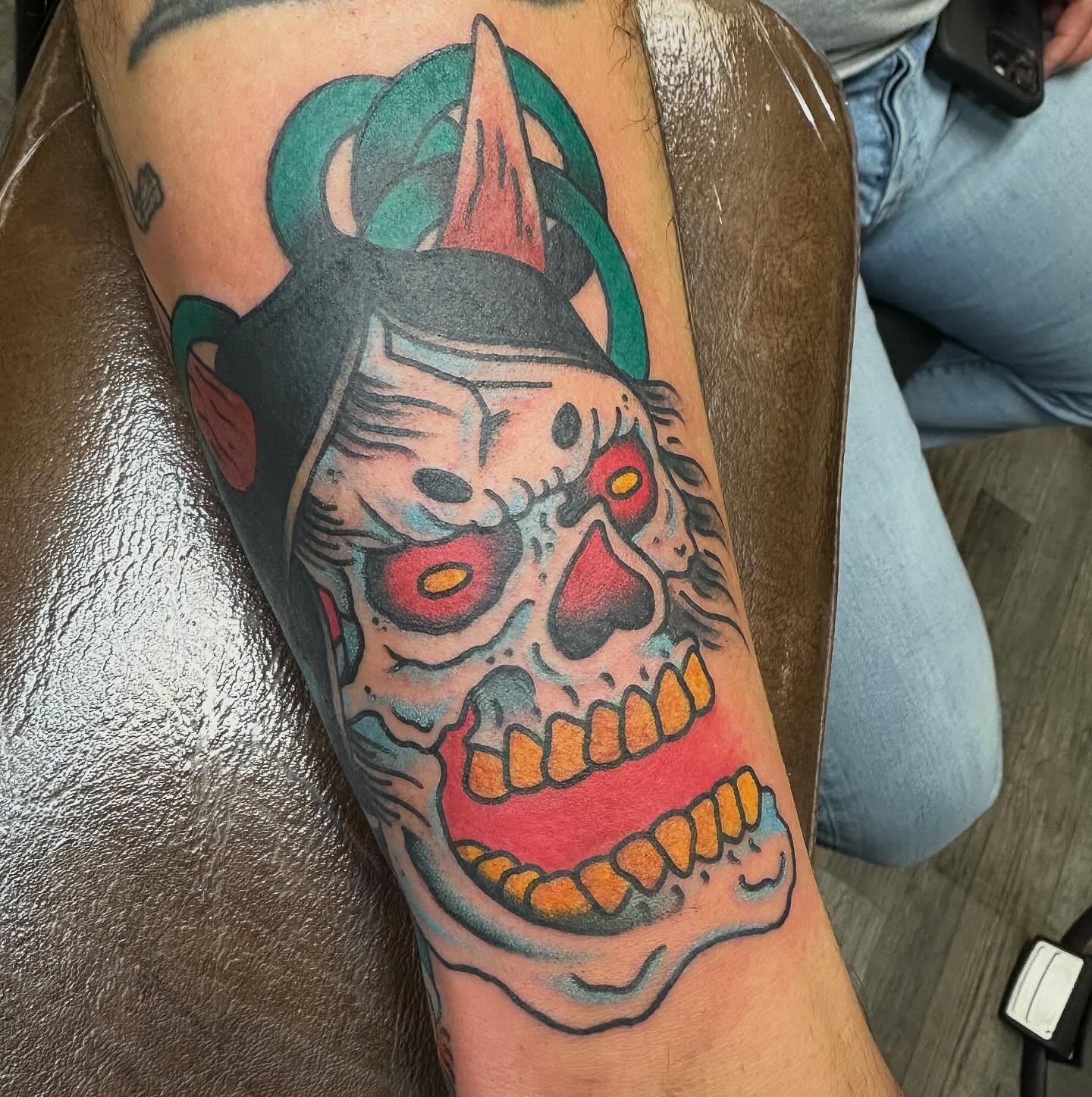 Skull with horns American traditional tattoo on the forearm by Devin Spenny