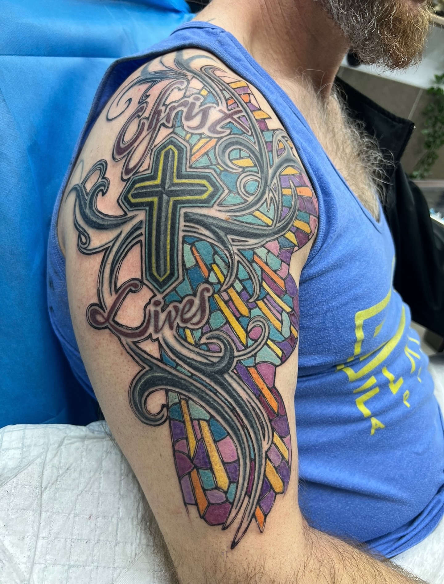 Cross with stained glass geometric tattoo on the shoulder by Steve Peace Calgary based tattoo artist, Calgary, Alberta