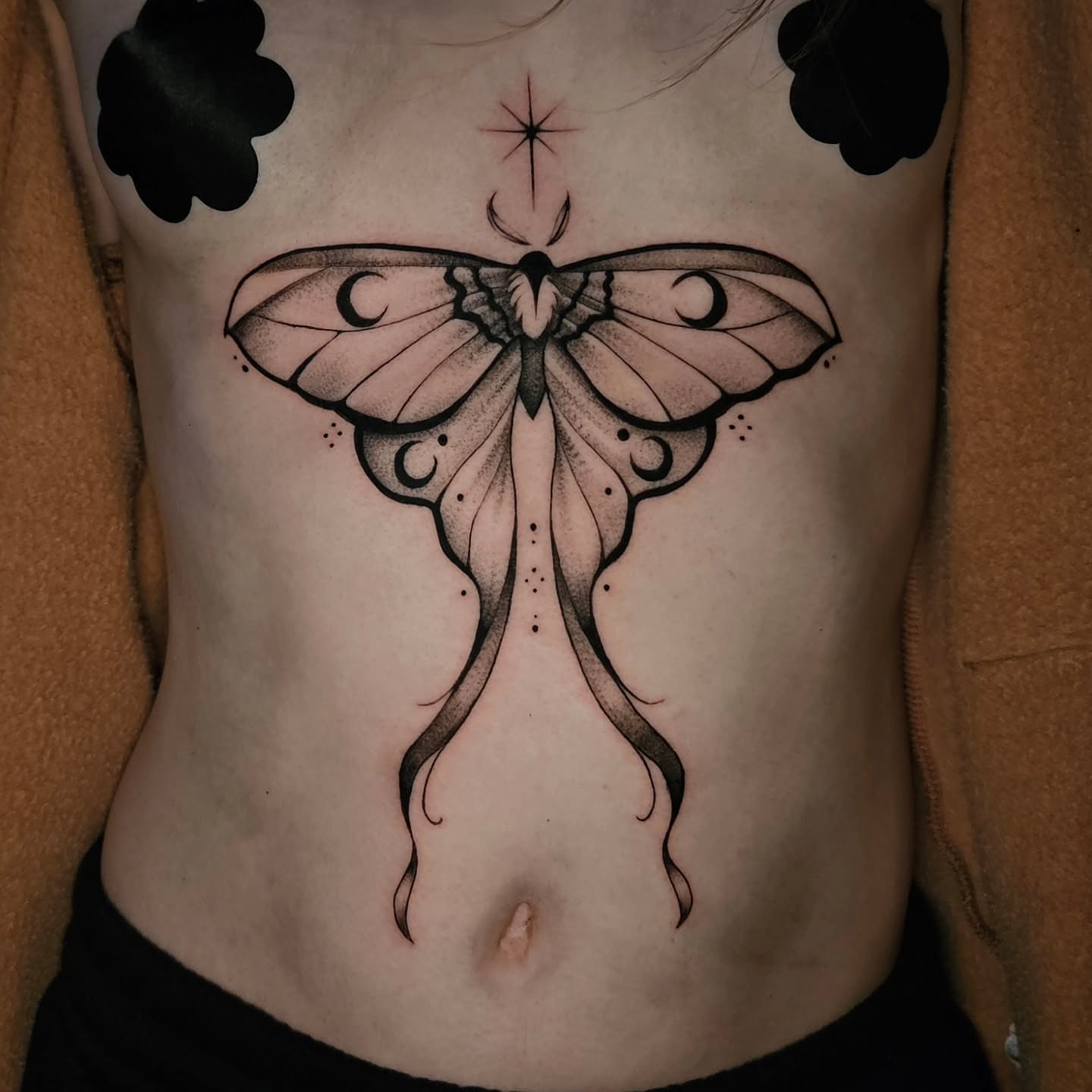 Moth dotwork tattoo on the ribs by Courtlyn Bliss