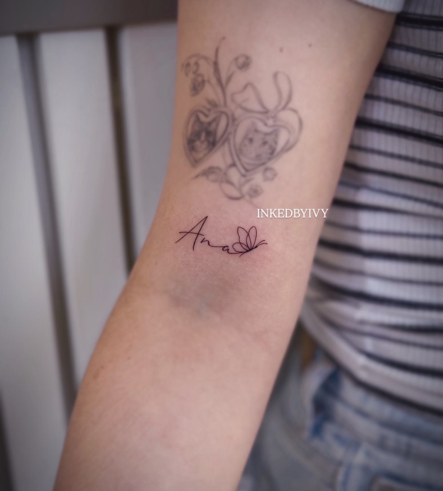 Name and butterfly fine line tattoo on the forearm by IVY