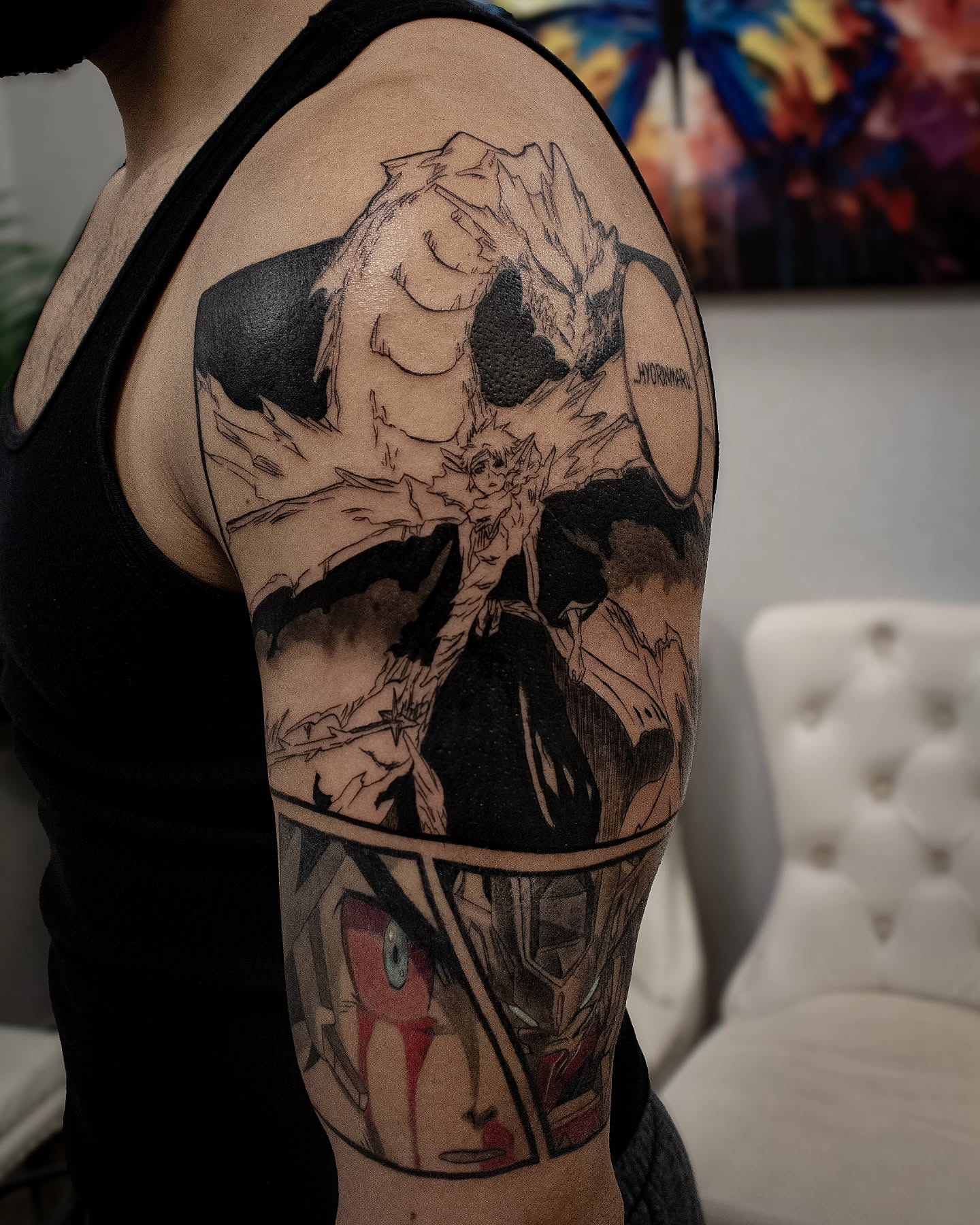 Anime character anime tattoo on the upper arm by Erik Bonilla