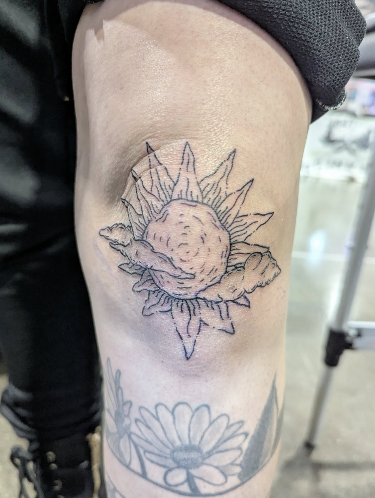 Sunflower black and grey tattoo on the thigh by Patricio