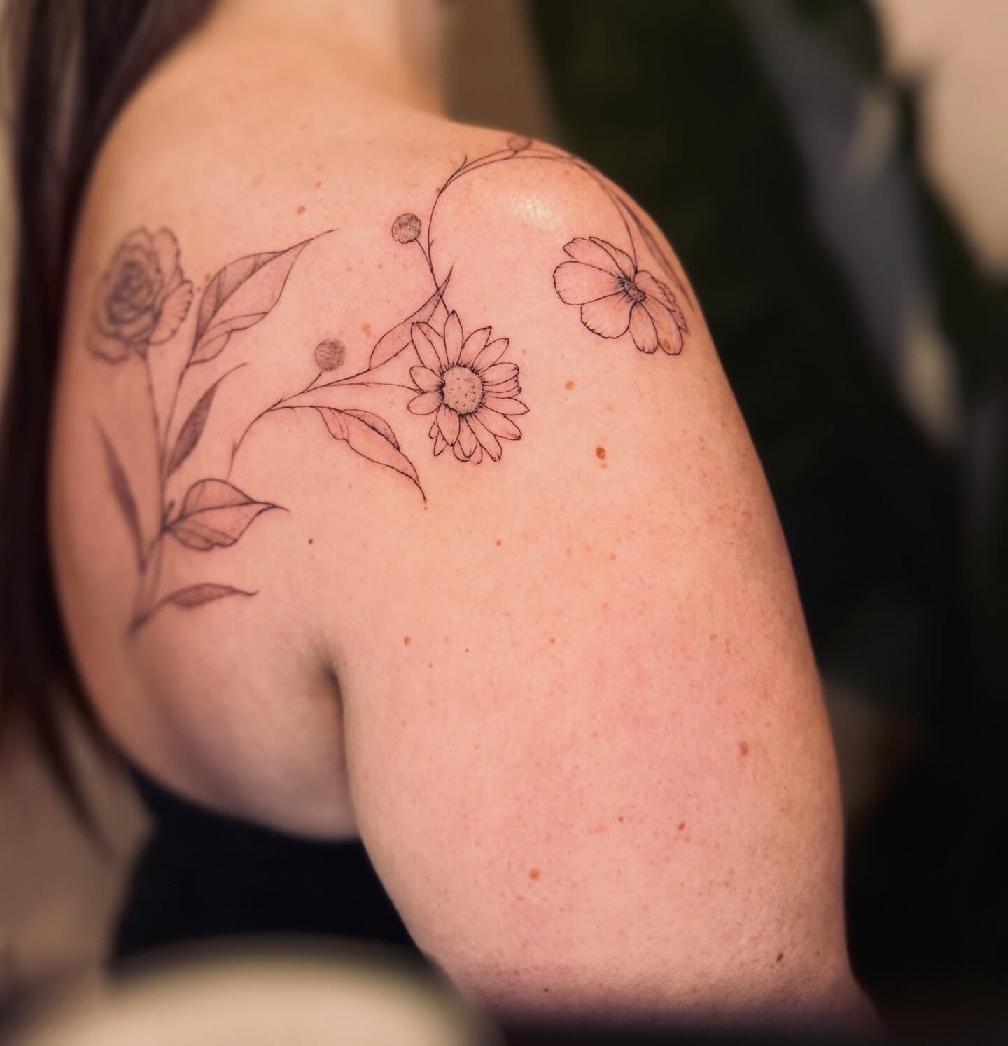 Floral arrangement dotwork tattoo on the shoulder by Ashley Pilgreen