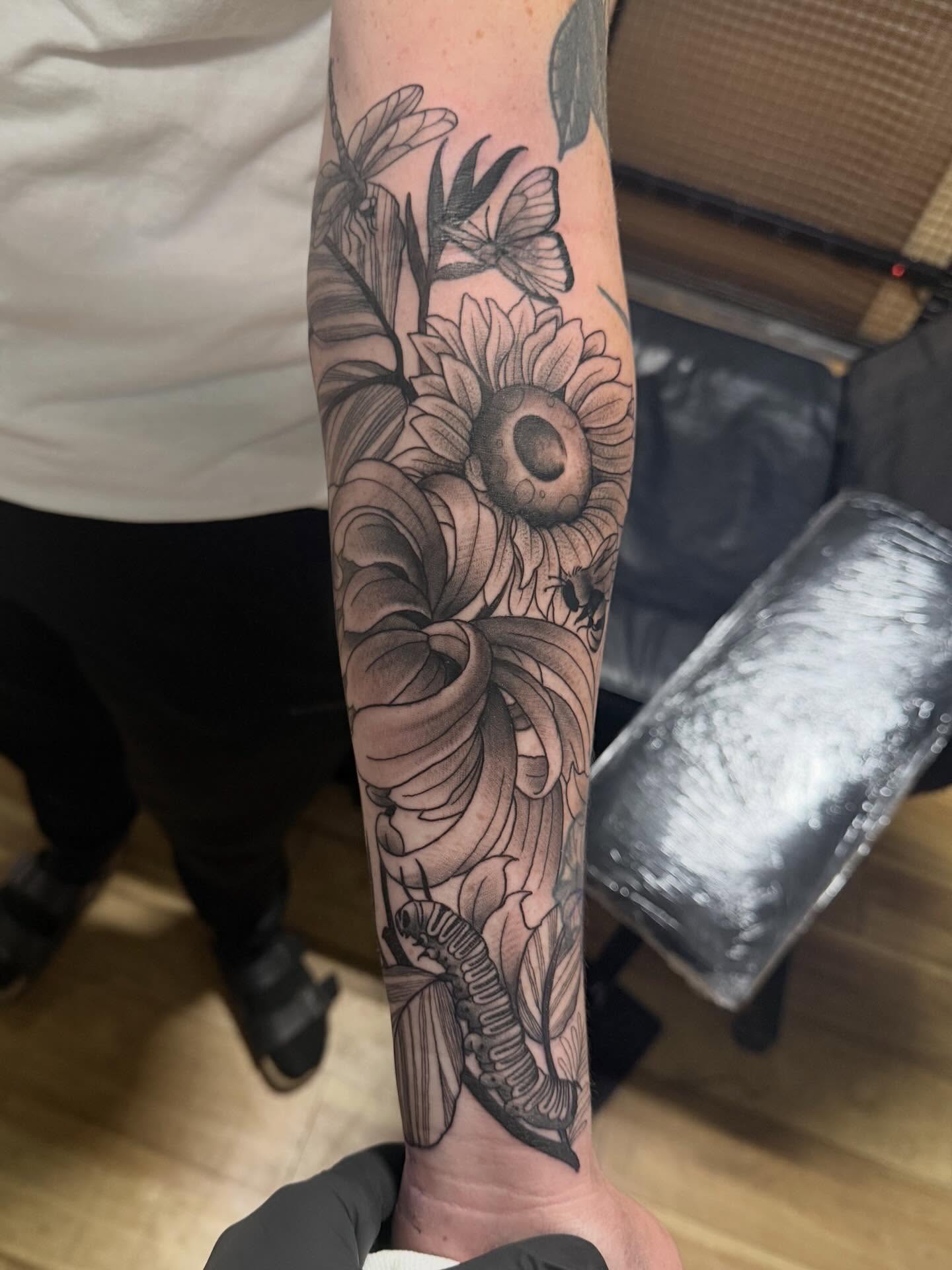 Sunflower and butterfly realism tattoo on the forearm by H.G