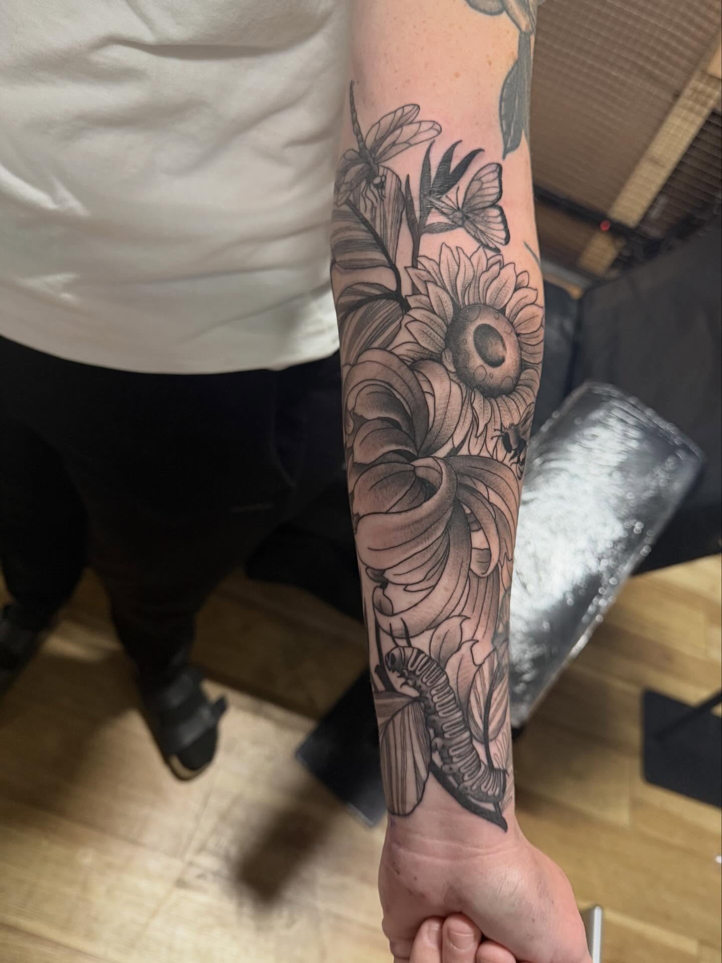 Floral arrangement realism tattoo on the forearm by H.G