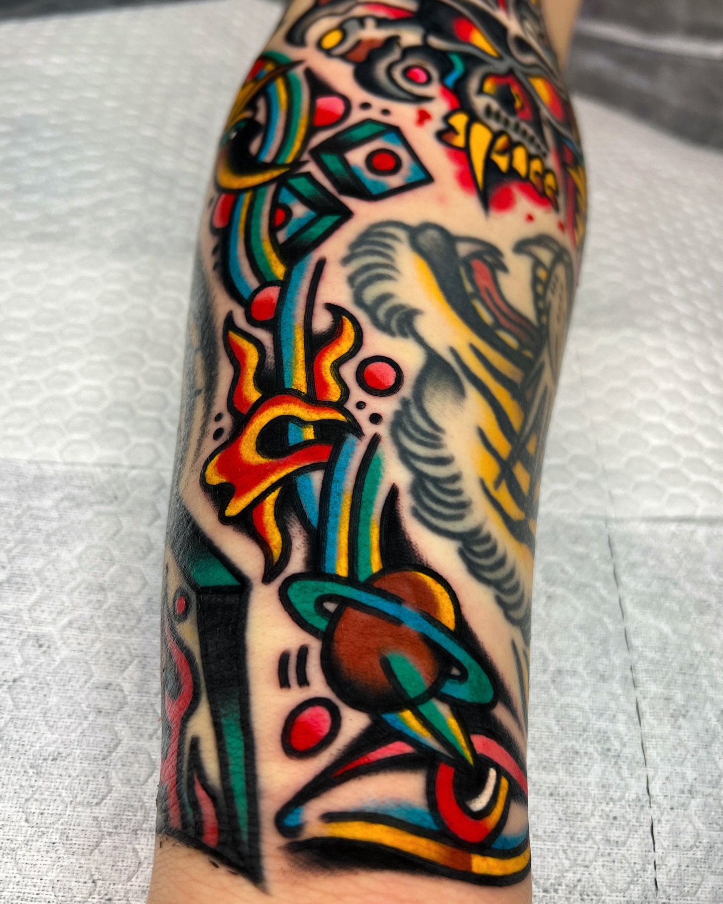 Astronaut and phoenix American traditional tattoo on the forearm by 올드스쿨타투 호무