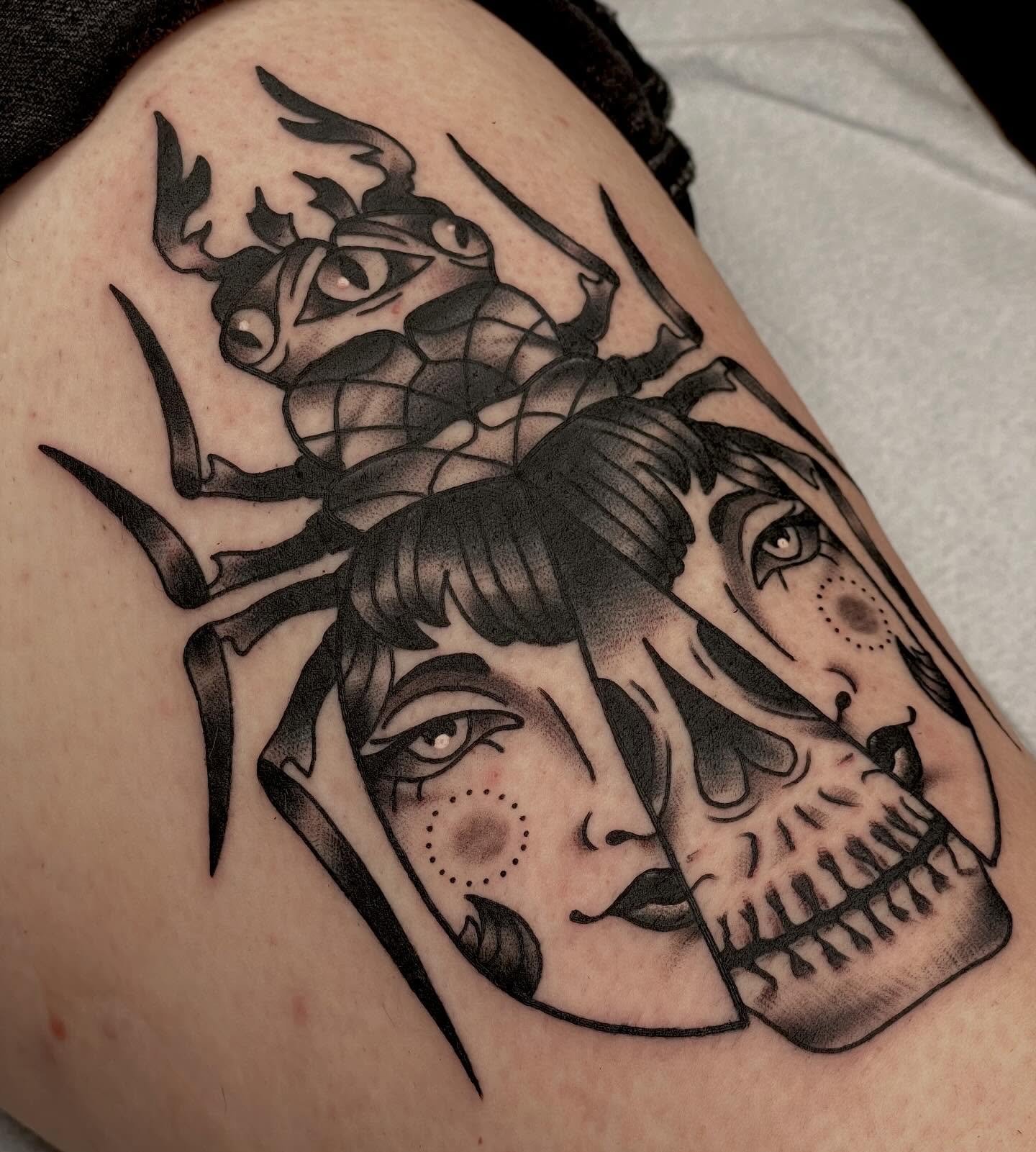 Woman's face with insect American traditional tattoo on the thigh by Beeker, Bellingham, Washington