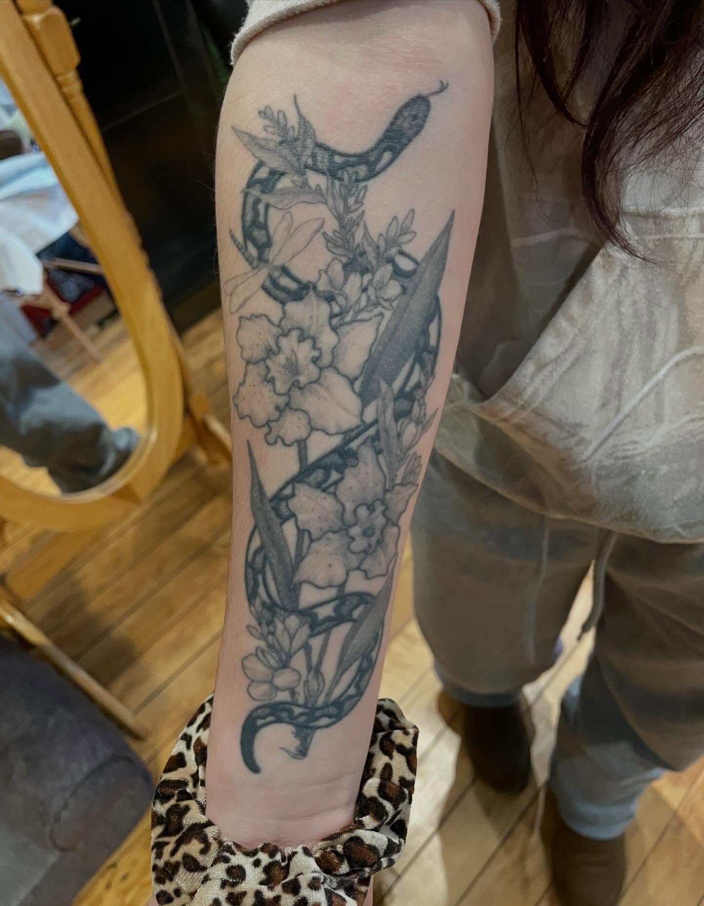 Snake and flowers black and grey tattoo on the forearm by Lake Stephens, Richmond, Virginia