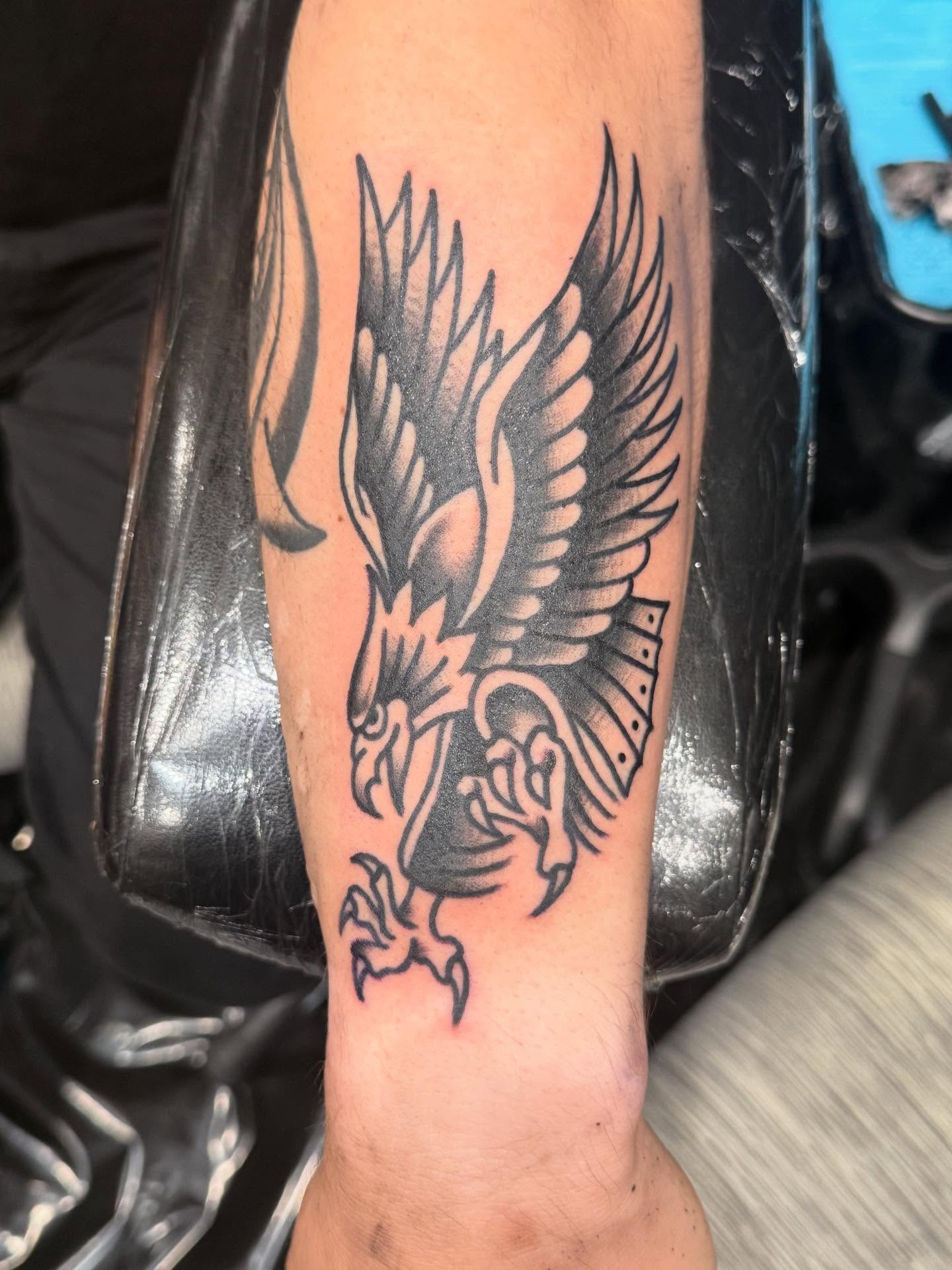 Eagle black and grey tattoo on the forearm by Jesse Coldiron