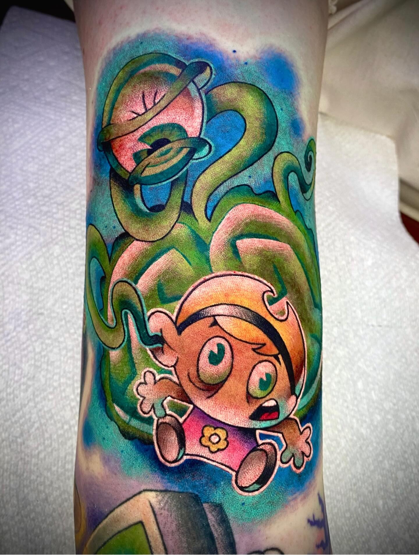 Ben 10 new school tattoo on the forearm by Zach Knisley (Wiz)