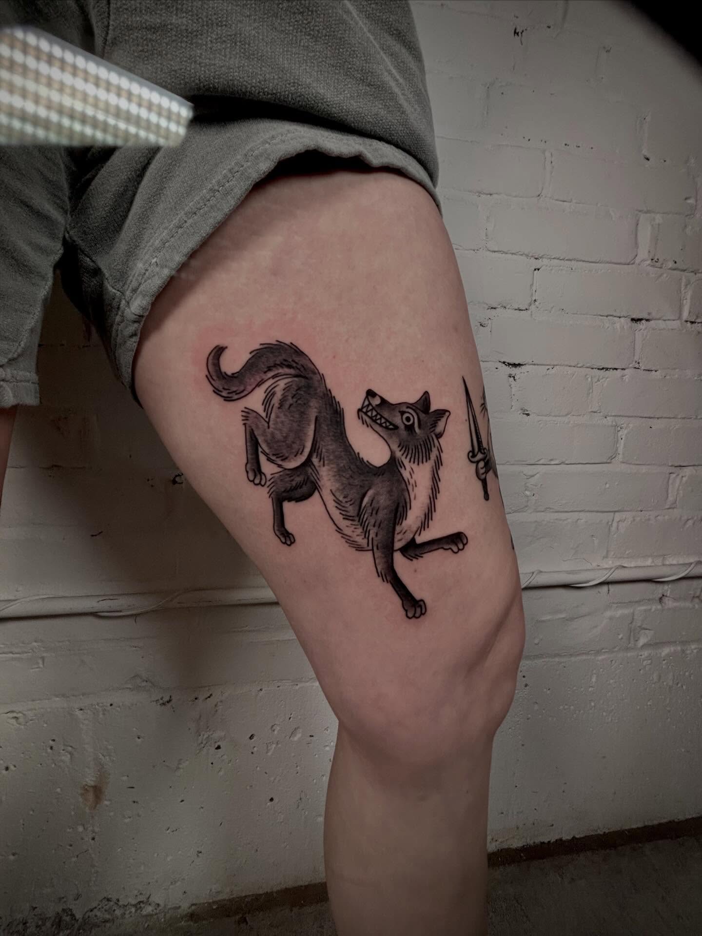 Cat black and grey tattoo on the thigh by Doug von