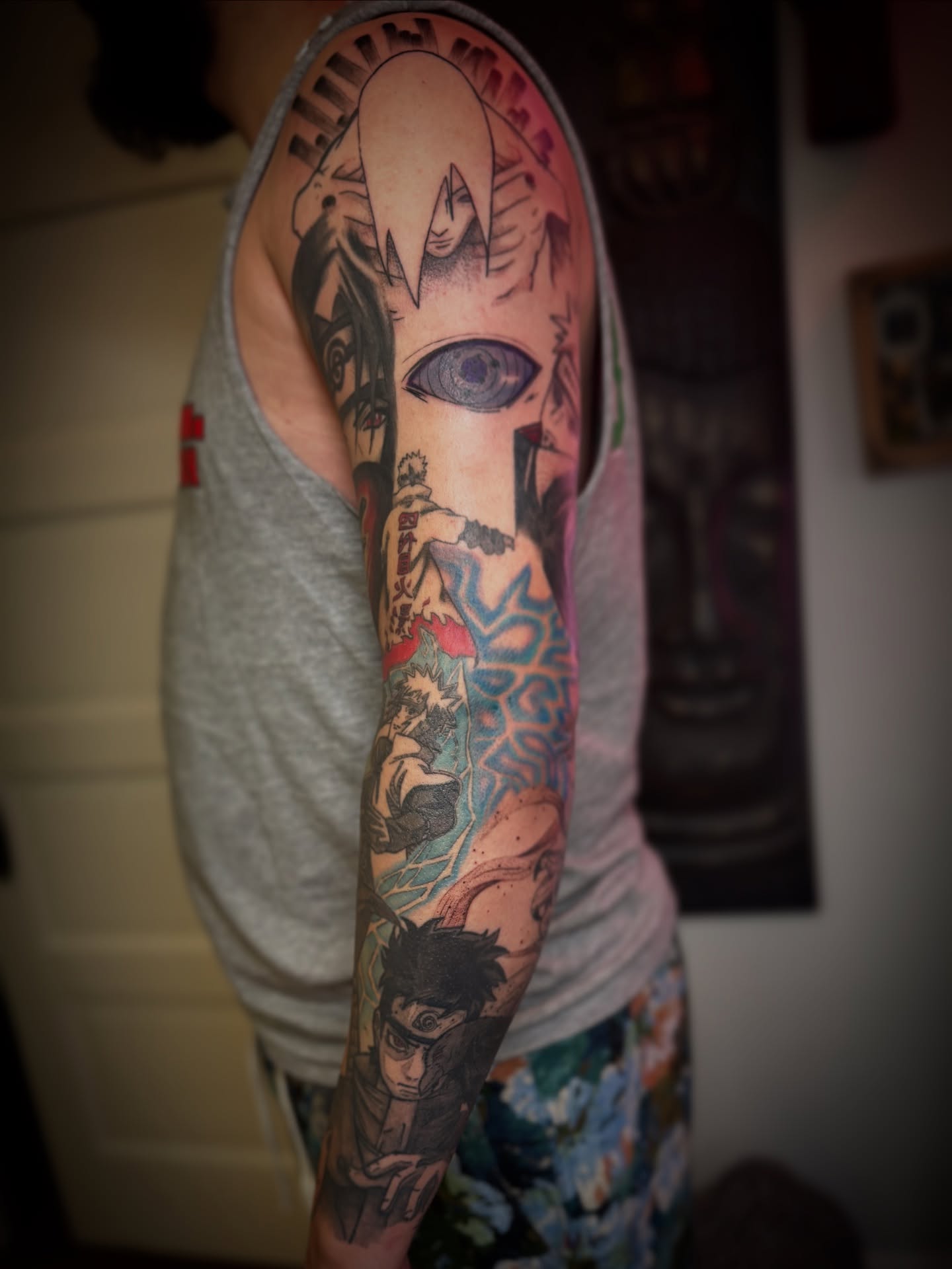 Anime characters anime tattoo on the upper arm by Gianna G