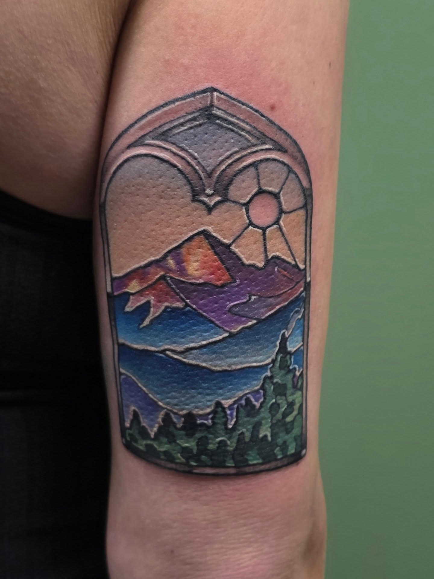 Mountain landscape watercolor tattoo on the forearm by Lizz Zonno, Naperville, Illinois