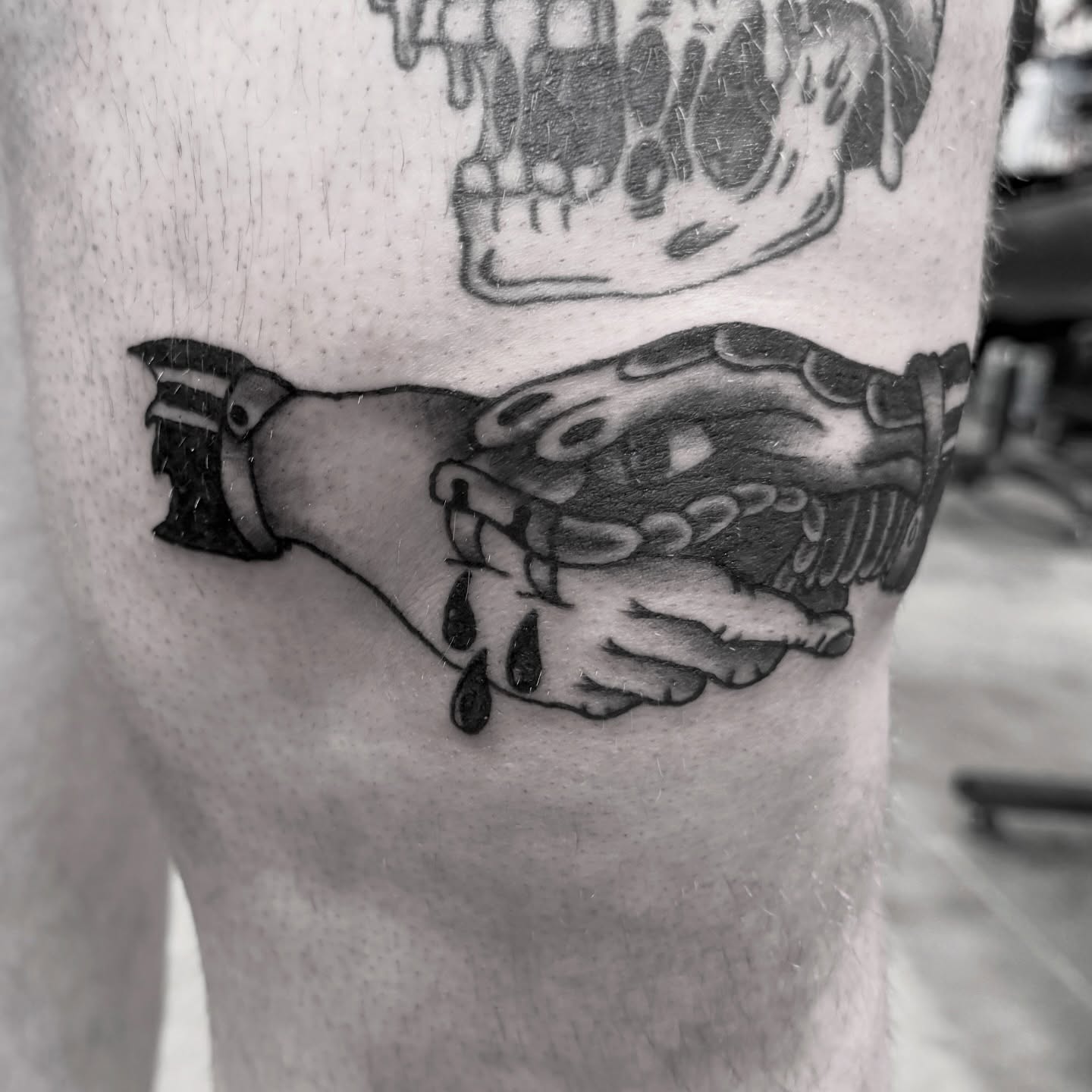 Skull and bottle black and grey tattoo on the forearm by Seth Christianson
