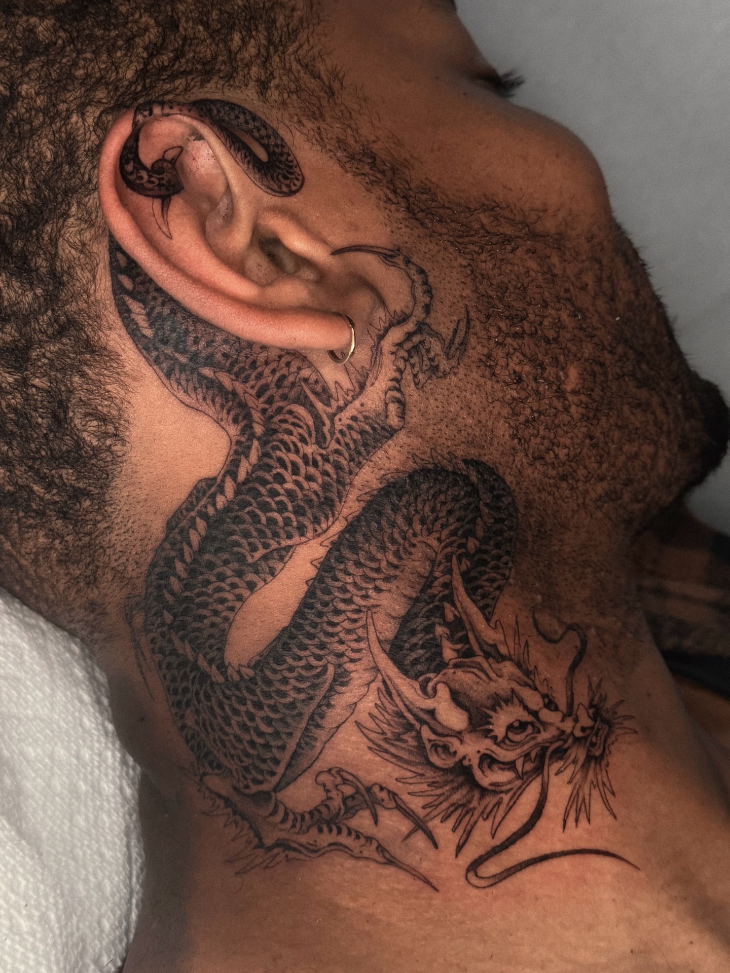 Dragon black and grey tattoo on the chest by ella