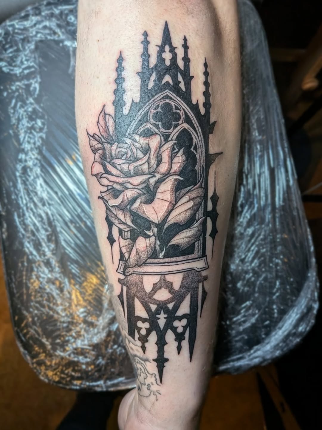Gothic window with rose realism tattoo on the forearm by Damon 🥀