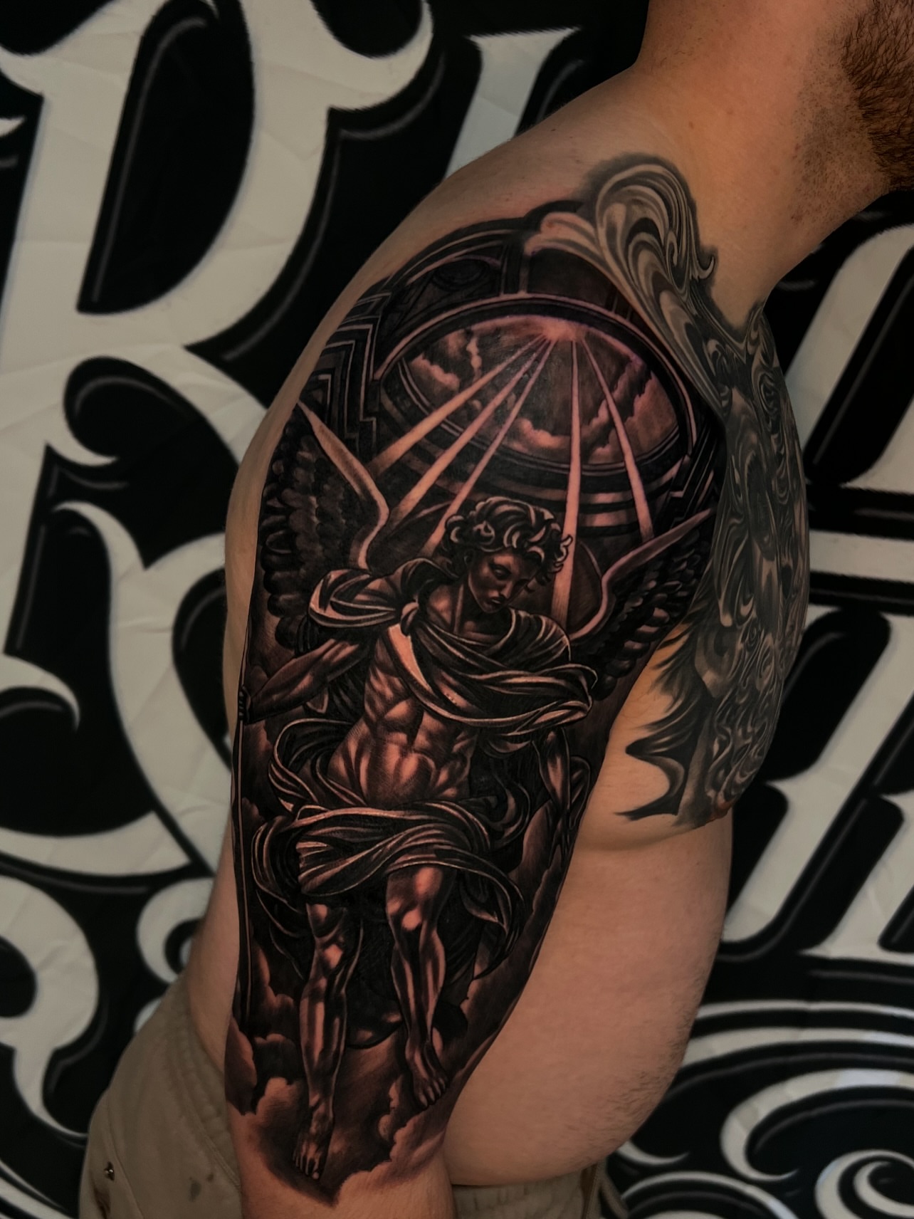 Angelic figure realism tattoo on the shoulder by Daniel Michael Perez