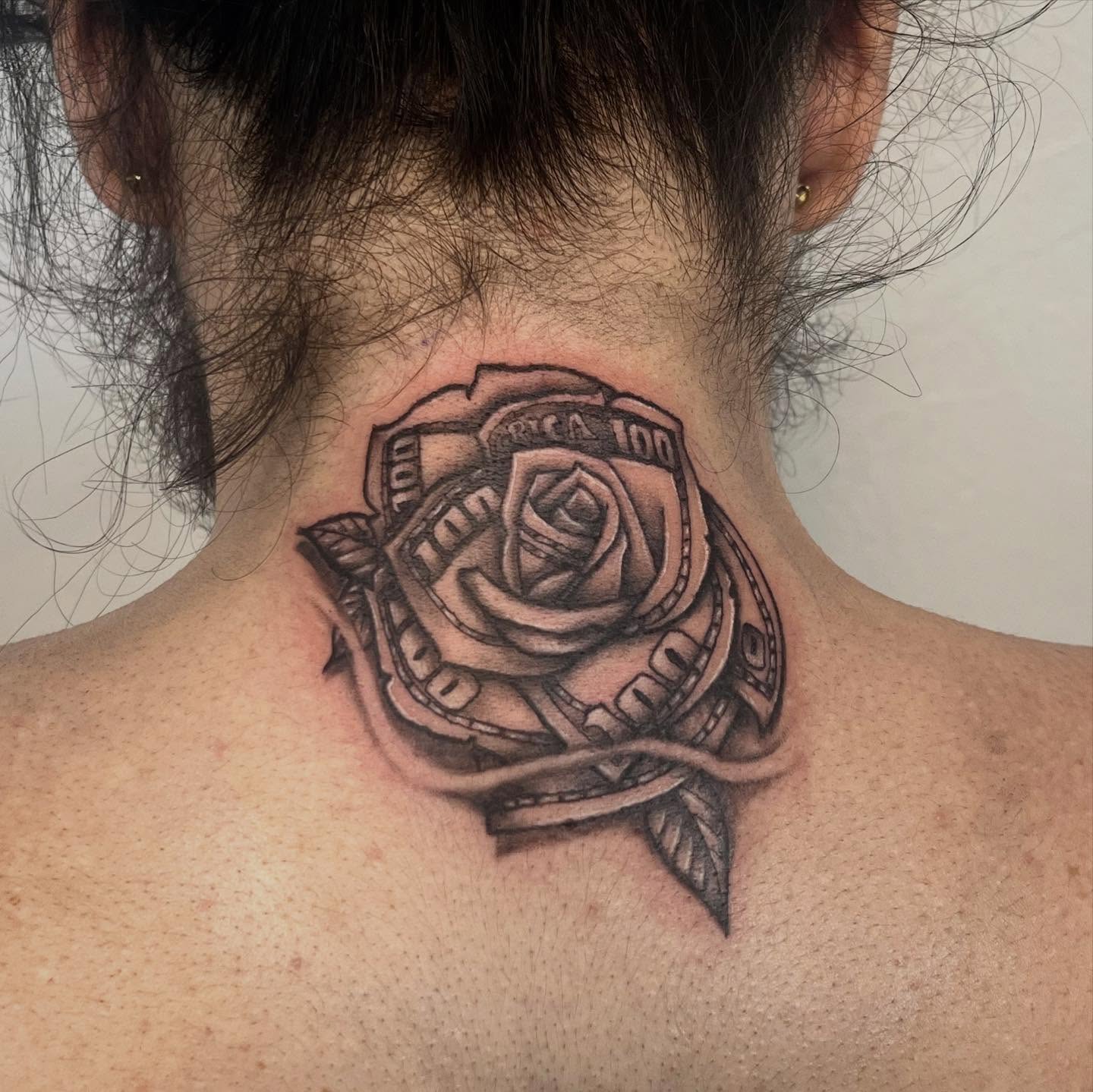 Rose and badge realism tattoo on the neck by Amber Rose