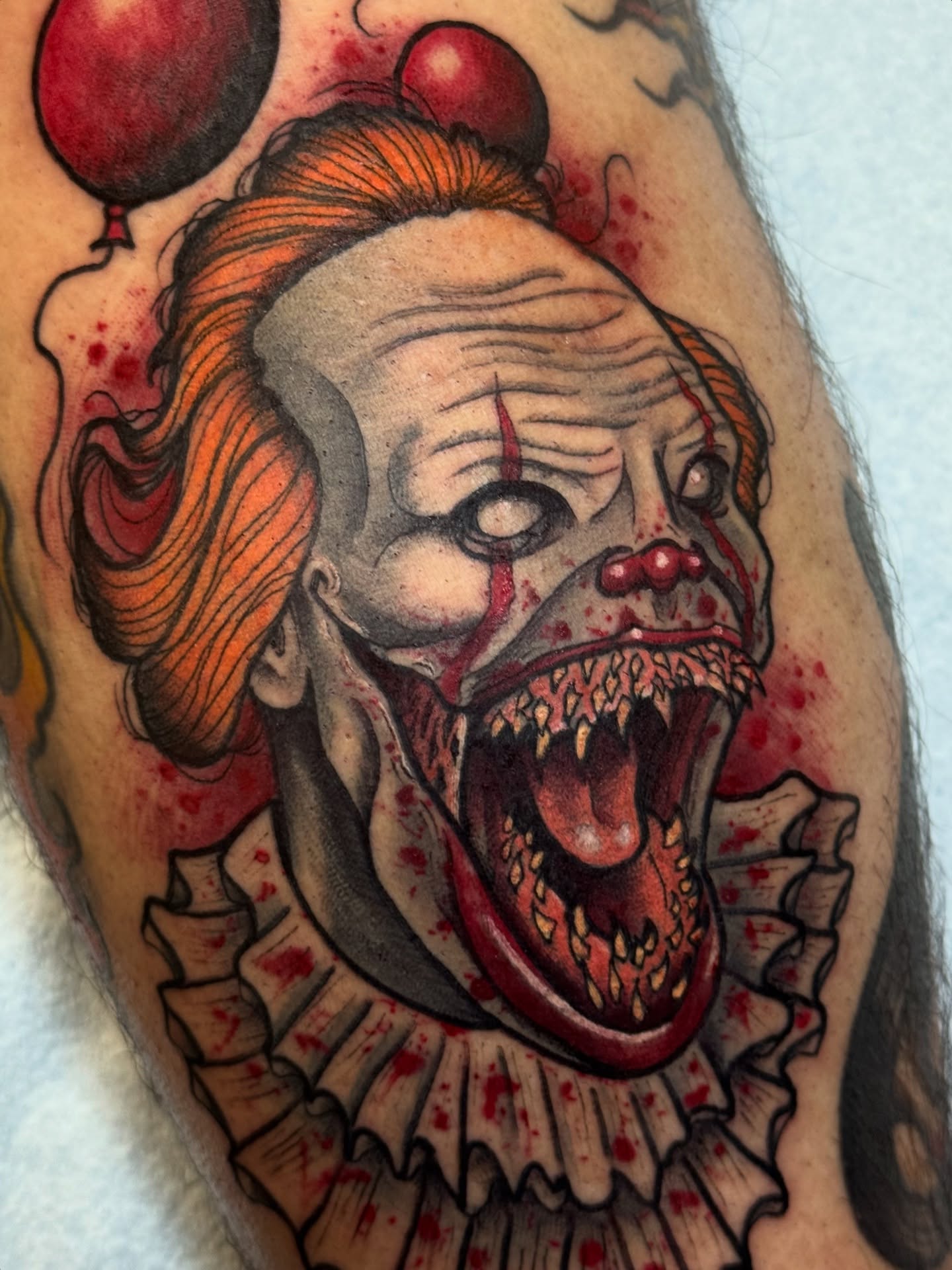Clown dark realism tattoo on the forearm by Mitch McGarry