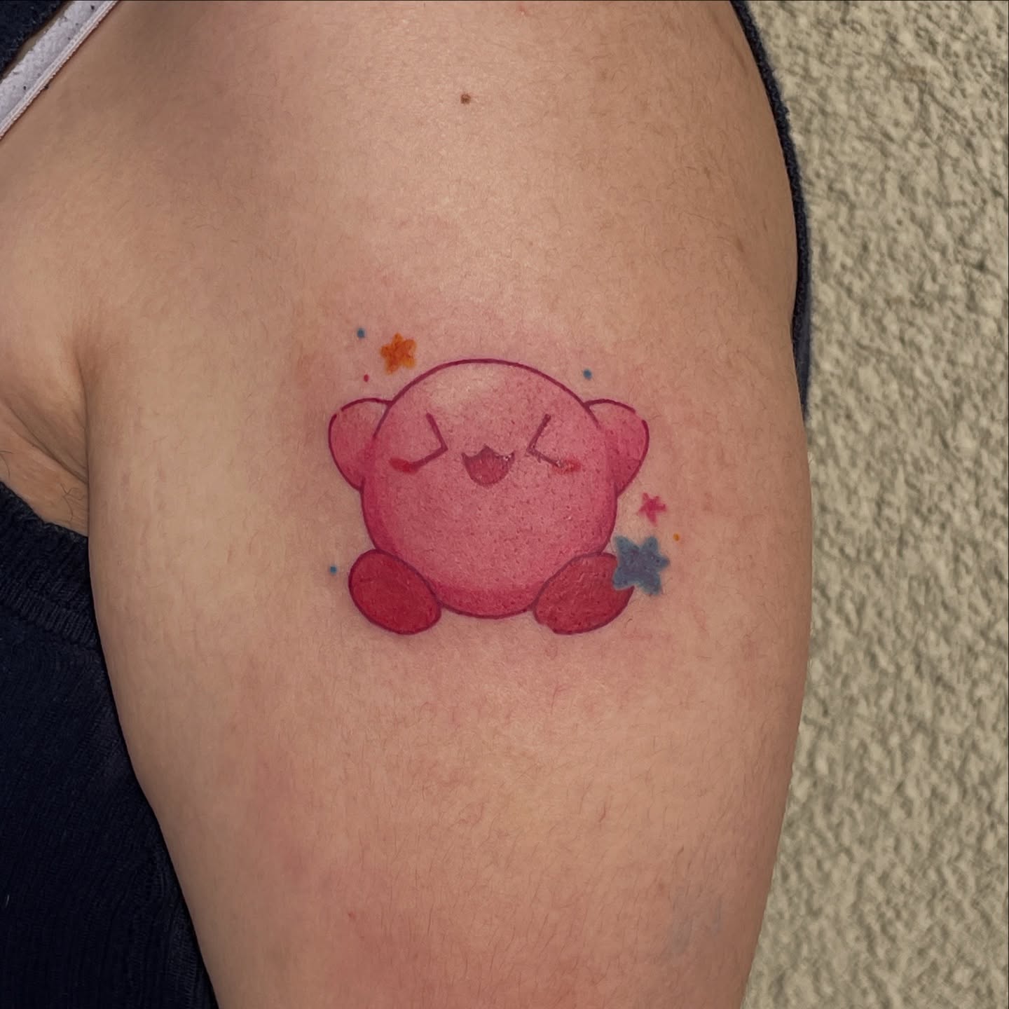 Kirby dotwork tattoo on the upper arm by Mia 	\(★ω★)