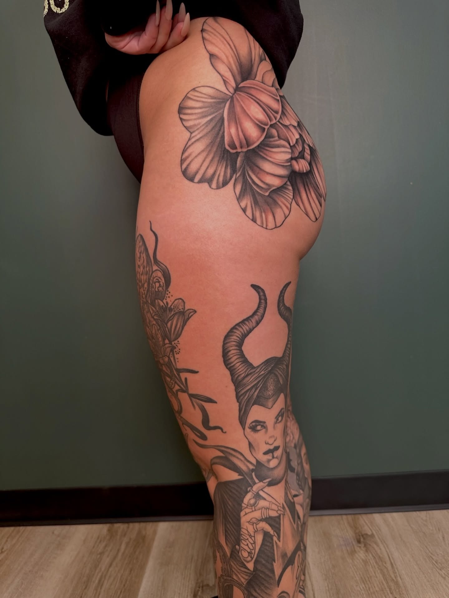 Maleficent black and grey tattoo on the thigh by Sarah Margaret