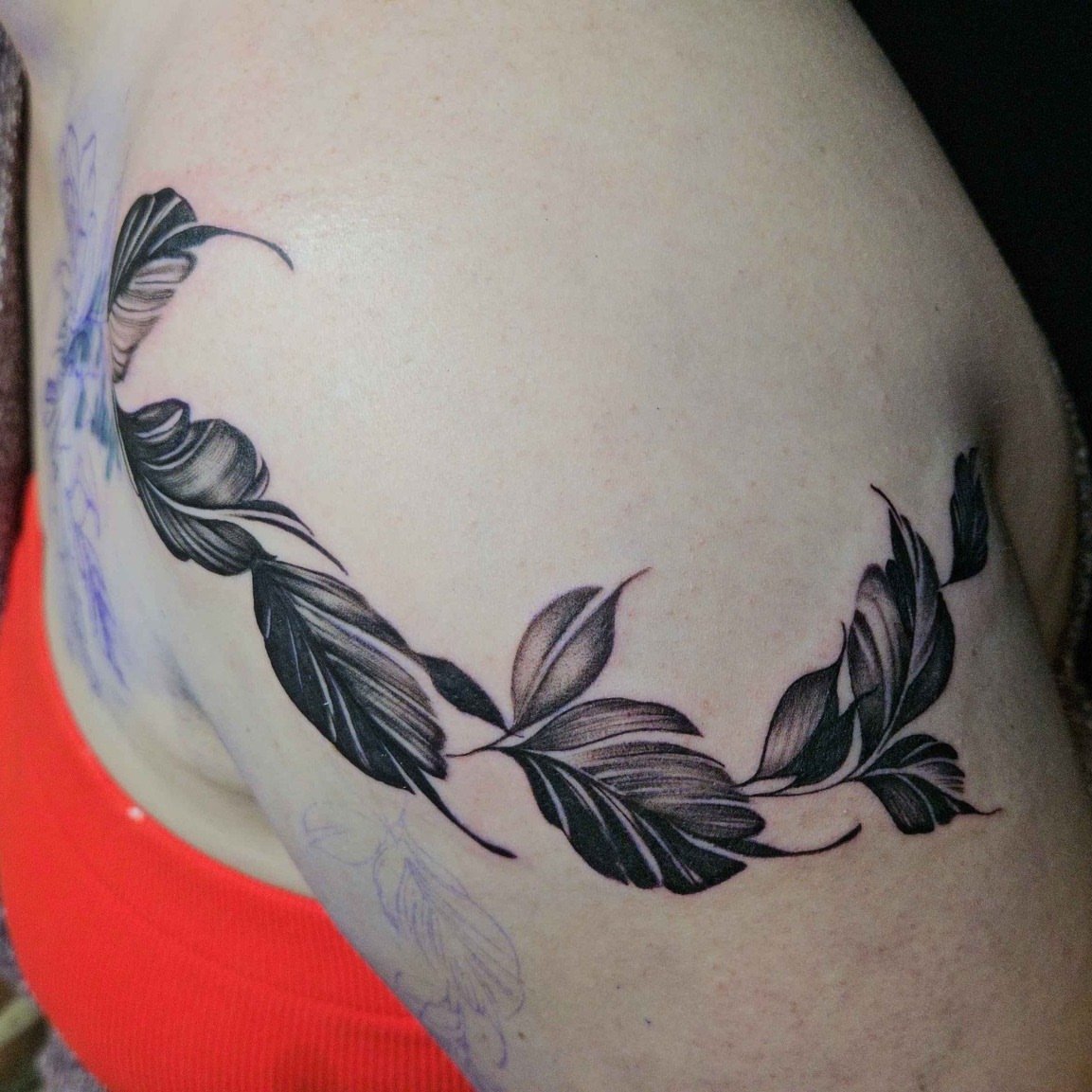 Feather wreath black and grey tattoo on the shoulder by Iram Withencroft