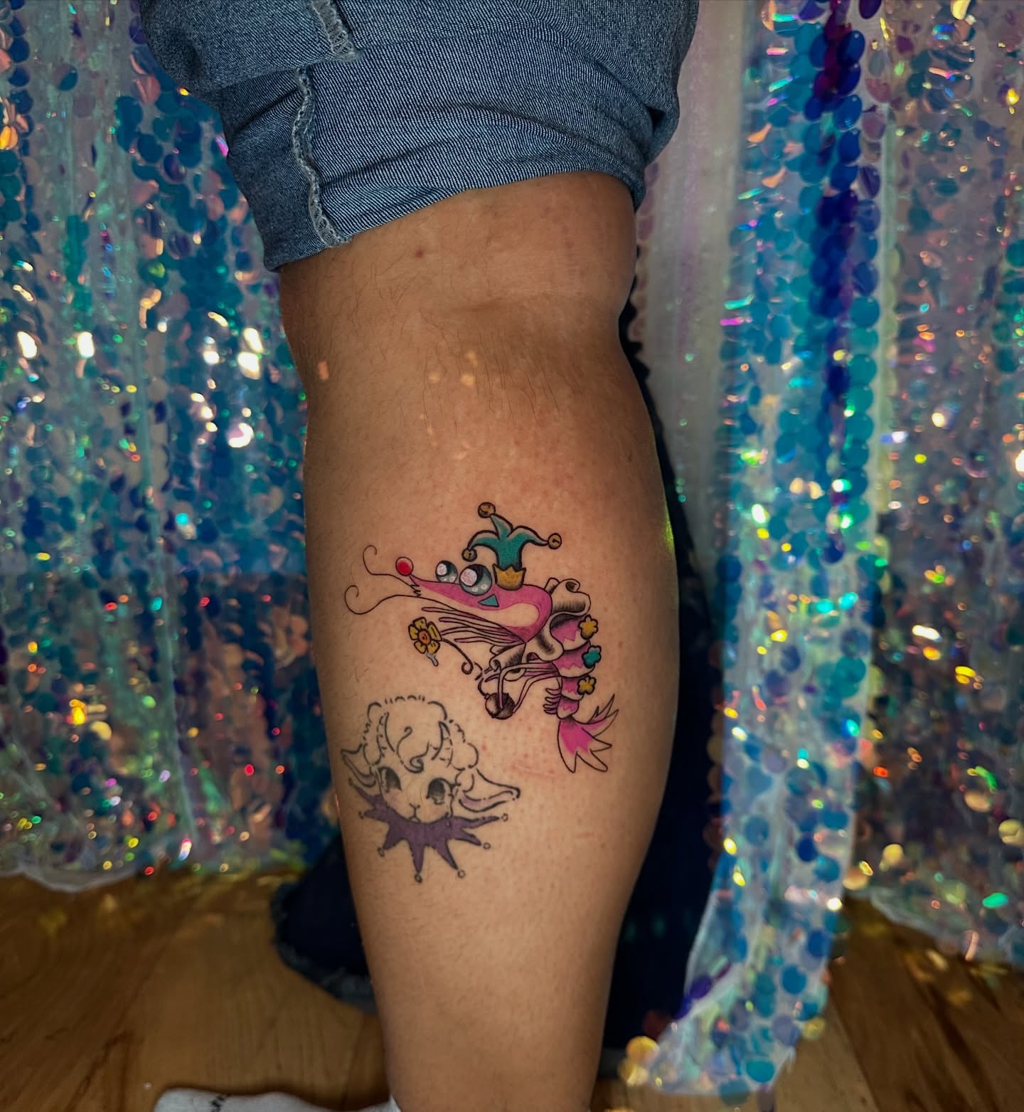 Jester hat and skull new school tattoo on the thigh by Sunny, Austin, Texas