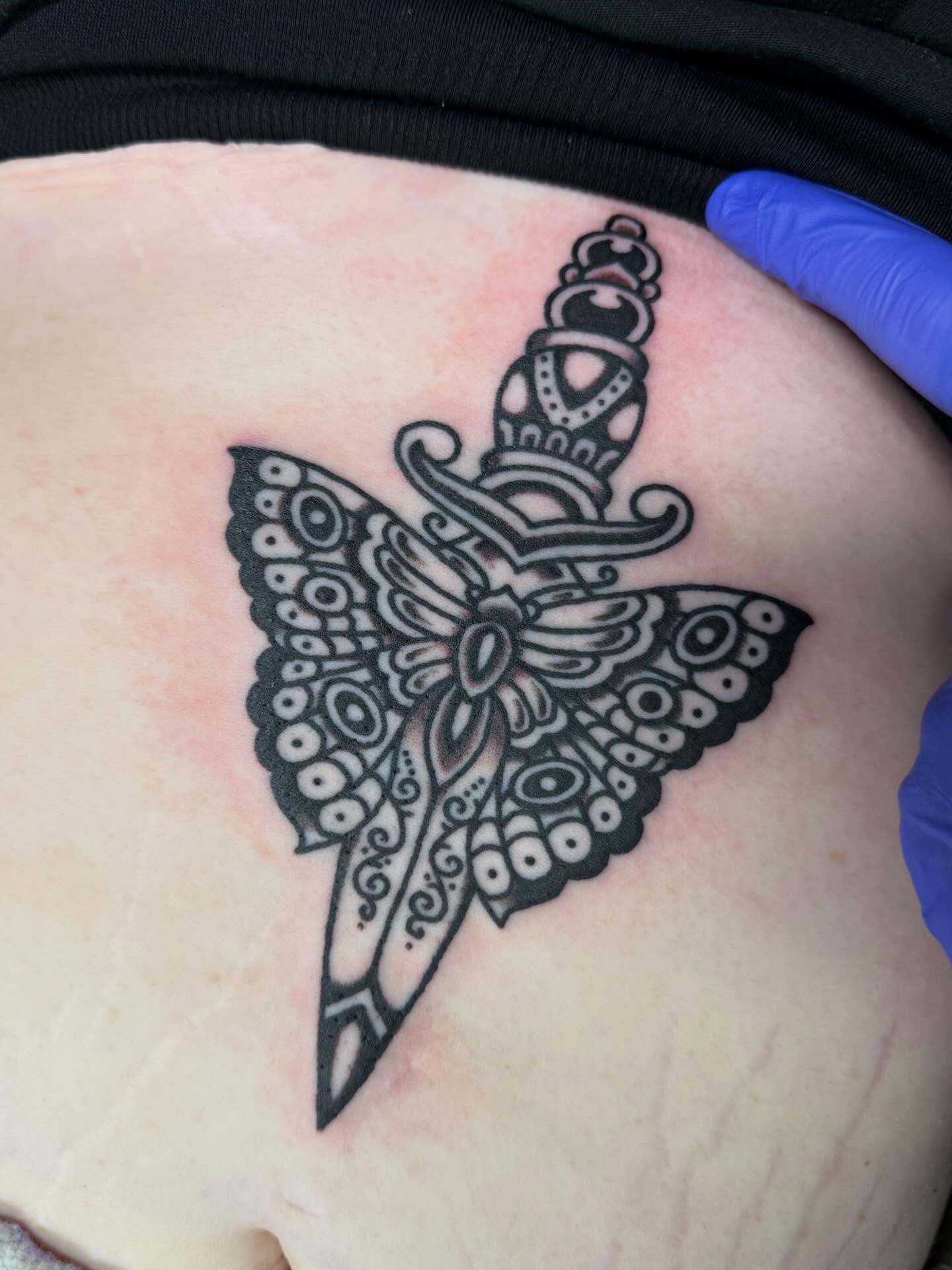 Butterfly ornamental tattoo on the chest by Bill Crawford, Plymouth, Michigan