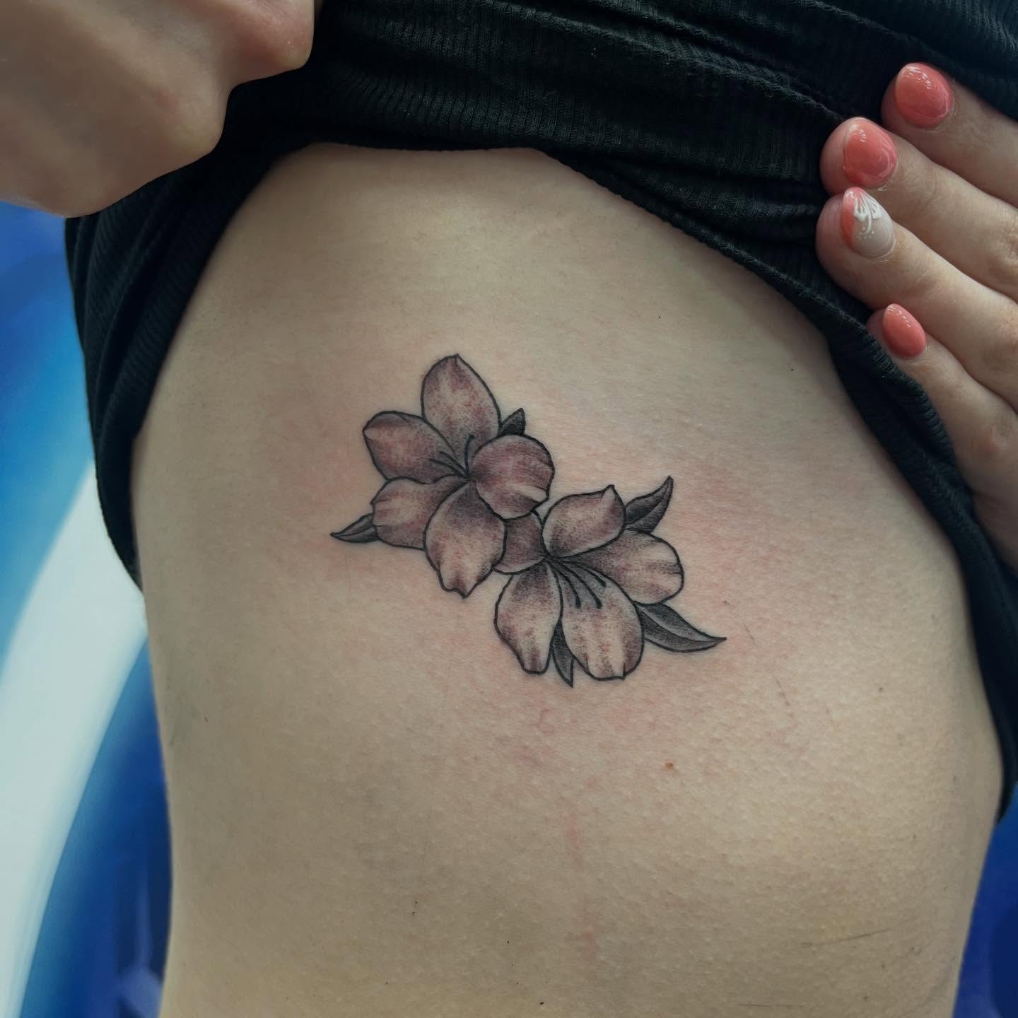 Cherry blossoms black and grey tattoo on the thigh by Franky Sharpz