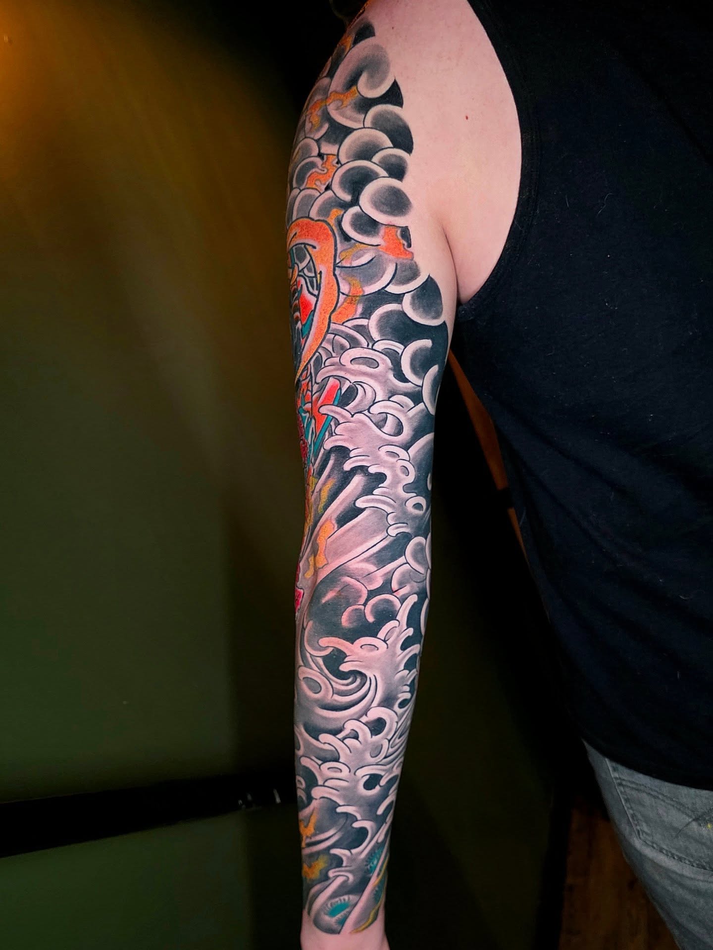 Waves and dragon japanese irezumi tattoo on the upper arm by Frank Simanton