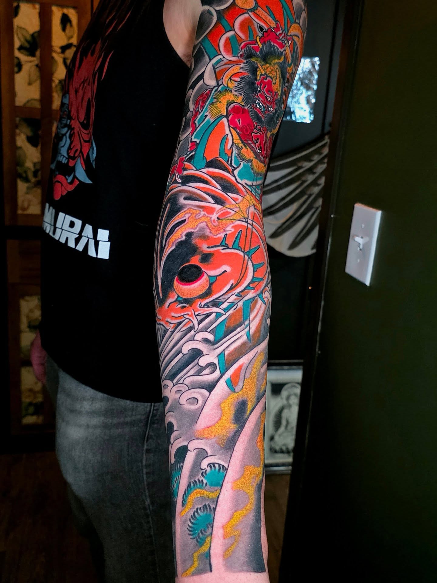 Koi fish and waves japanese irezumi tattoo on the forearm by Frank Simanton
