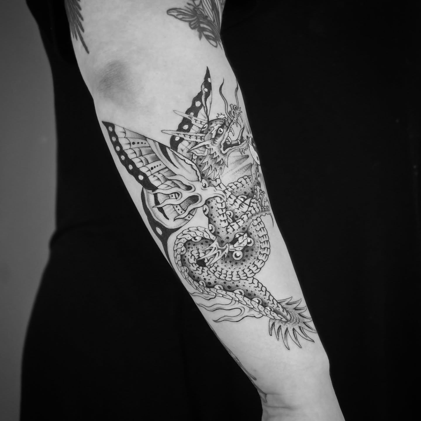 Dragon dotwork tattoo on the forearm by Aaron Dor