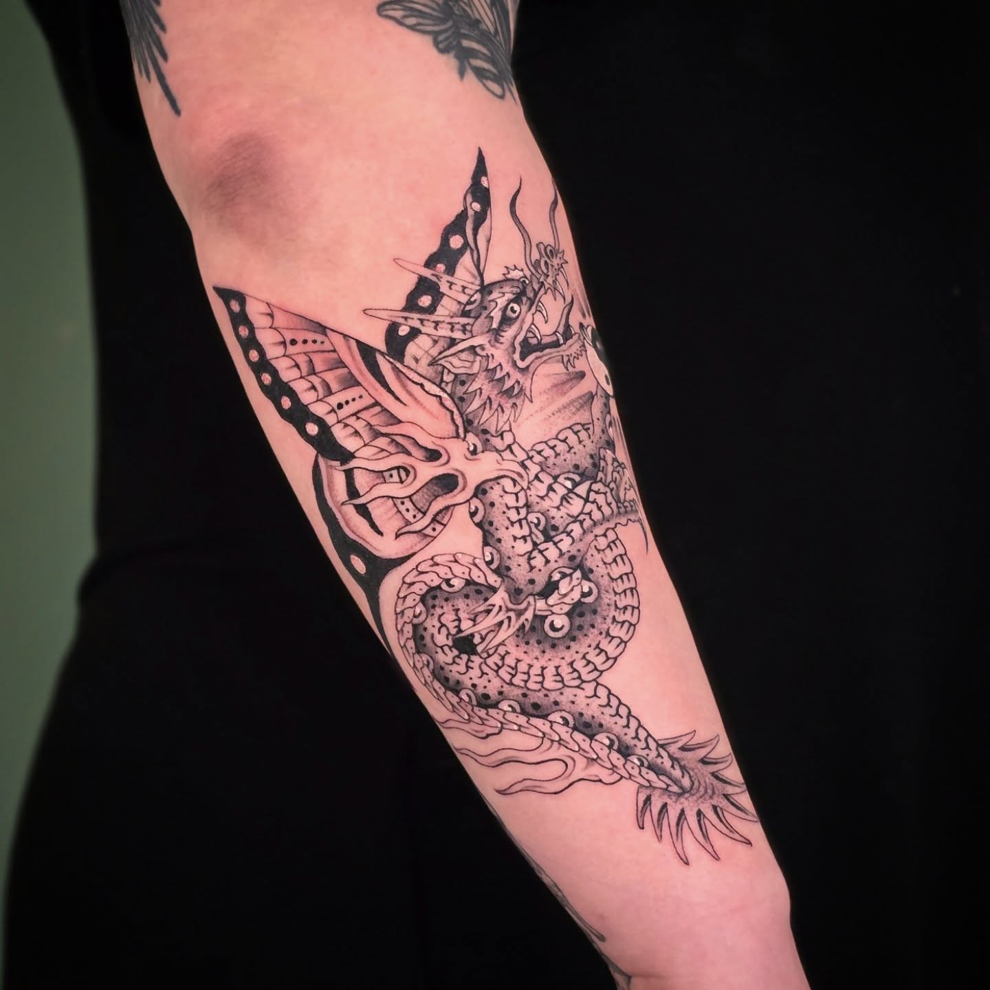 Dragon dotwork tattoo on the forearm by Aaron Dor