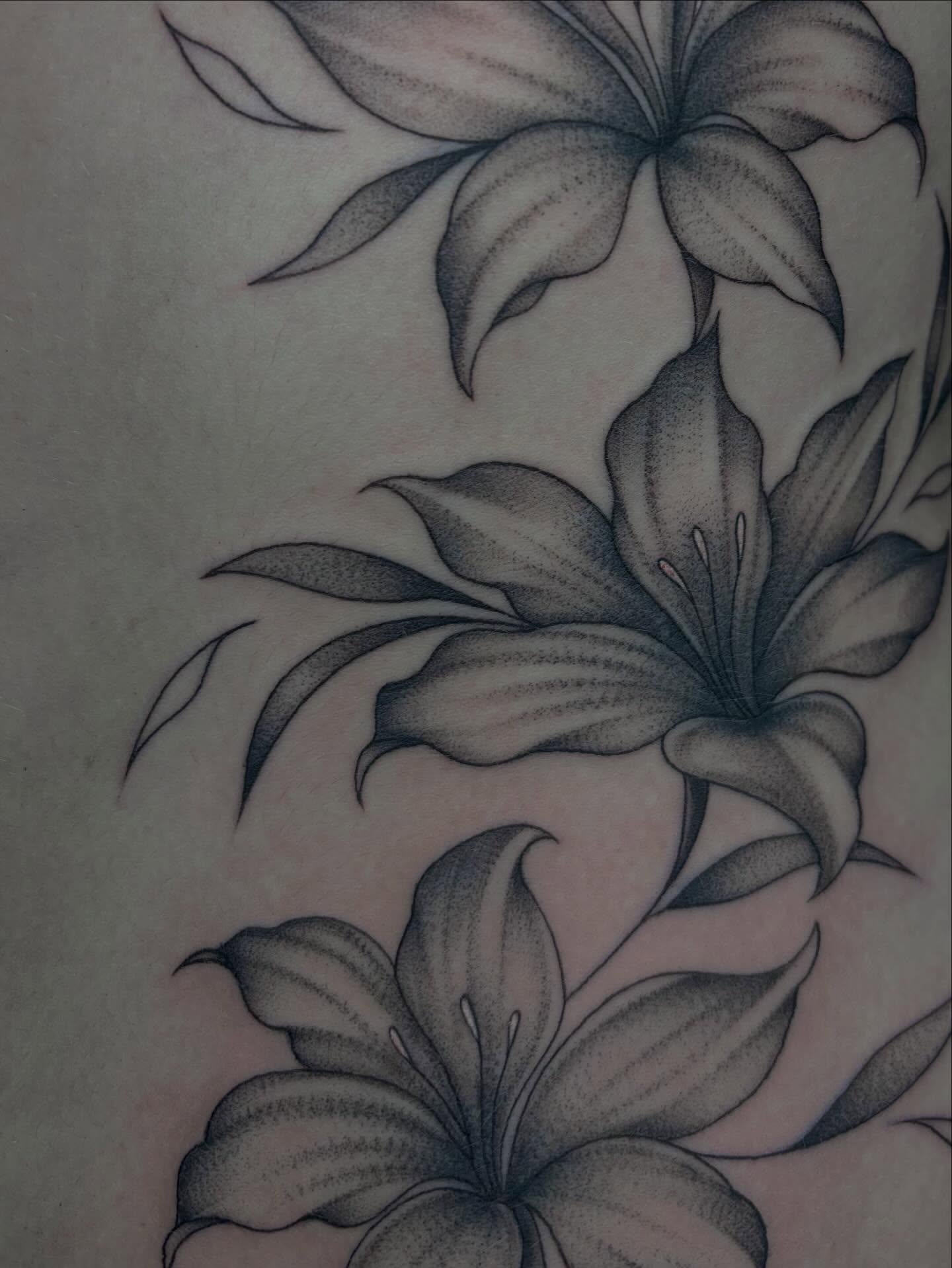 Lilies black and grey tattoo on the upper arm by ༺☆༻