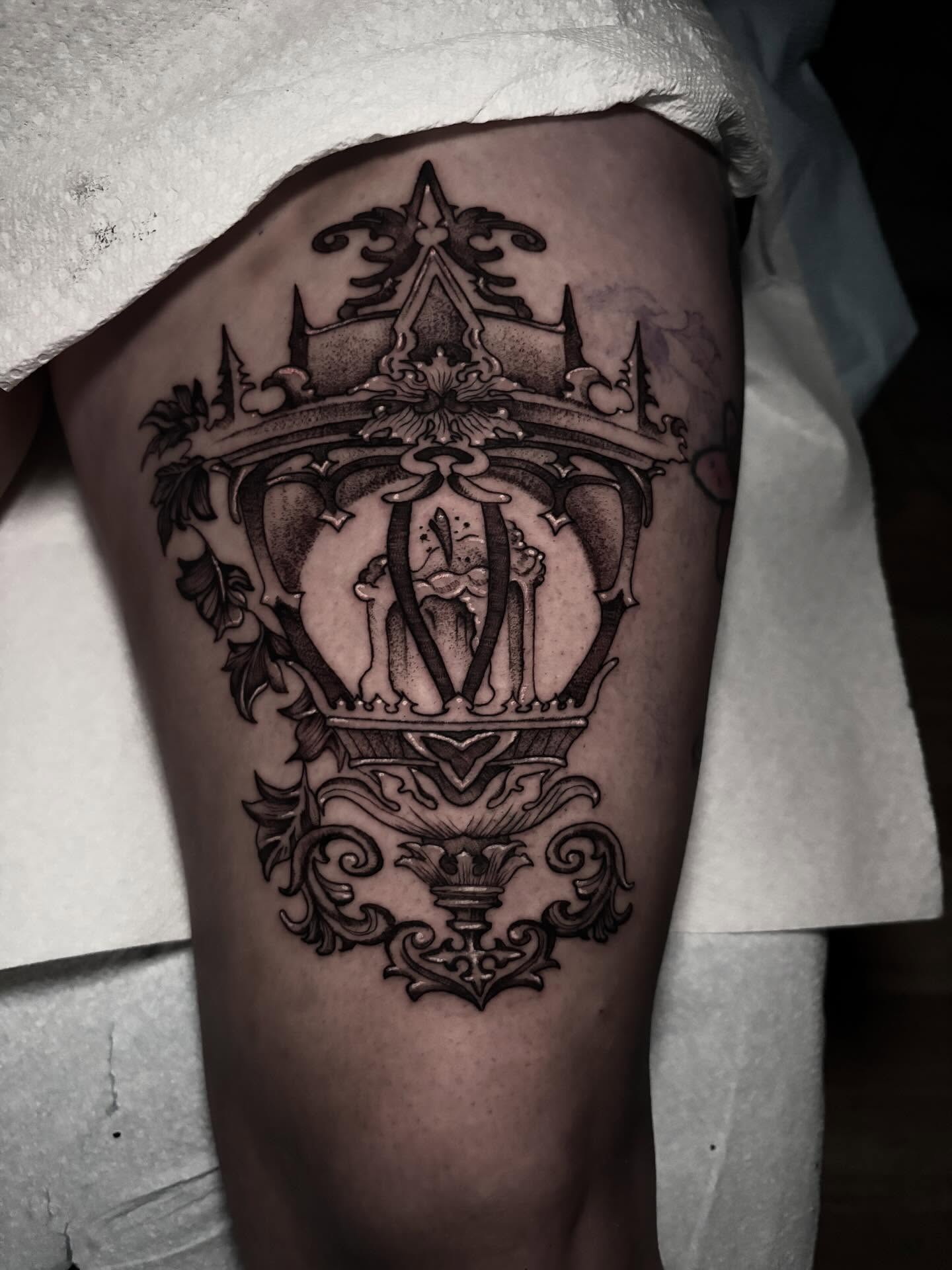 Royal crown black and grey tattoo on the thigh by Ashley Denise