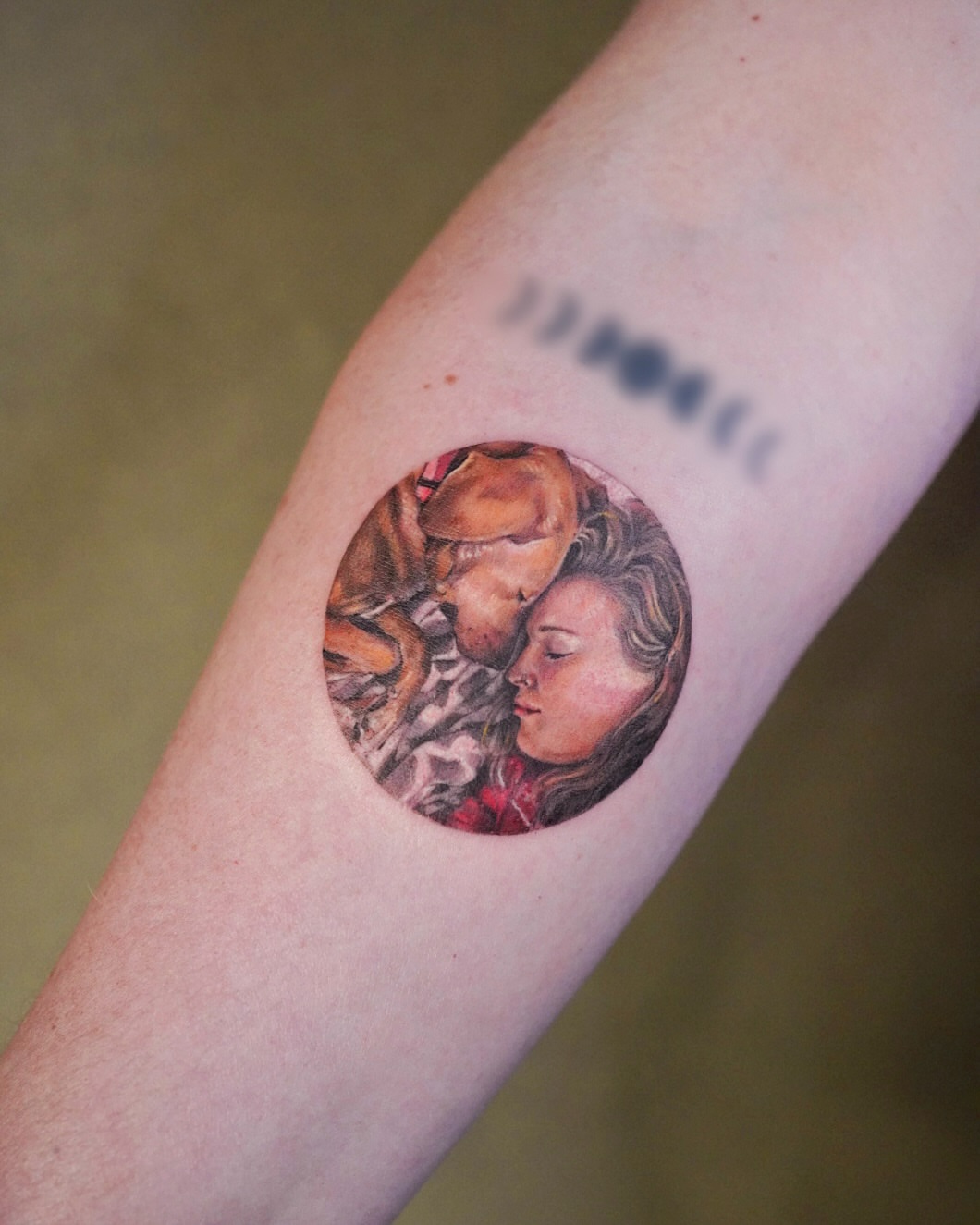 Couple embracing realism tattoo on the forearm by Lily, Los Angeles, California