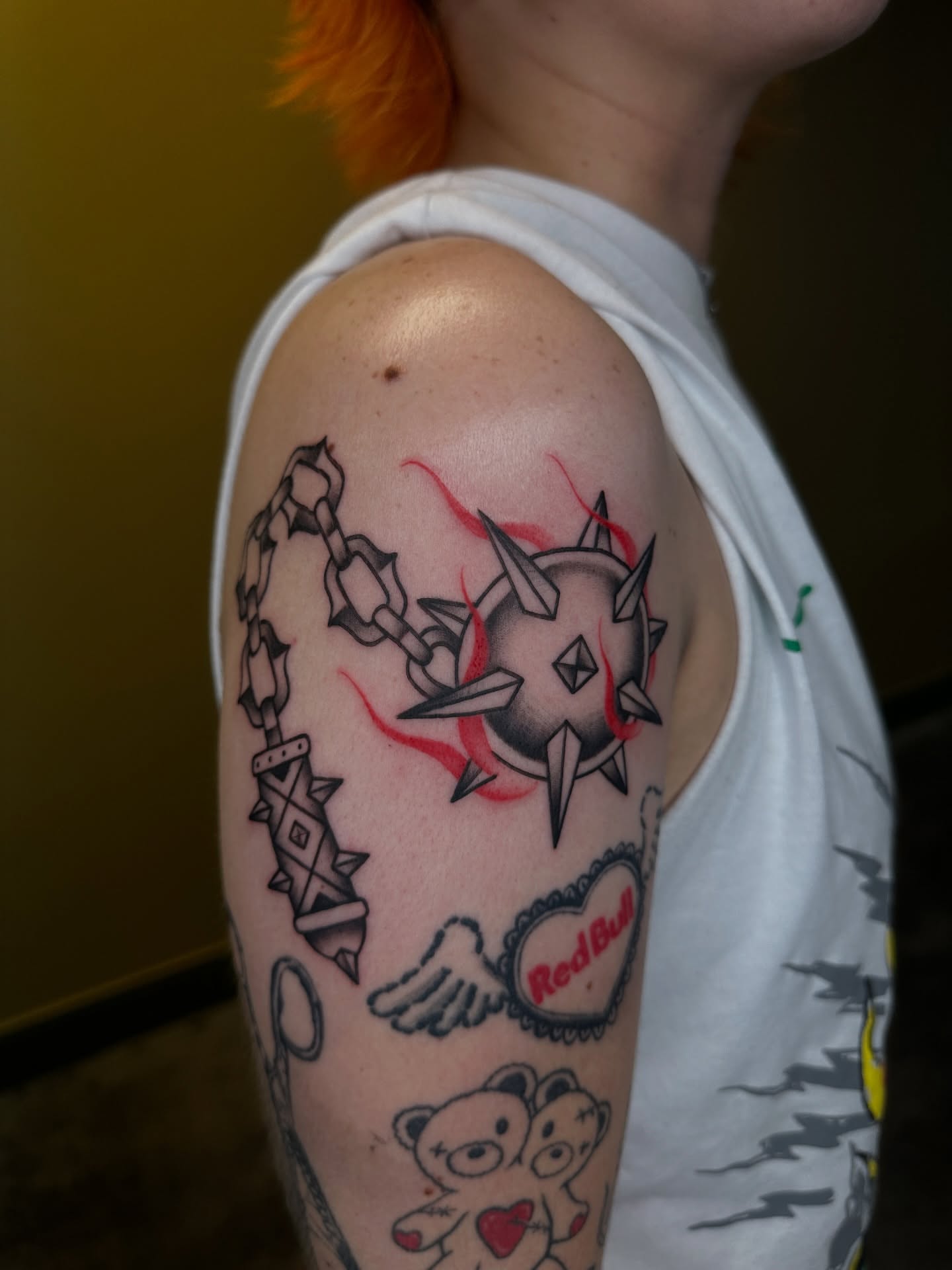 Chain and spiked ball neo-traditional tattoo on the upper arm by Fabian💉 Tattoo artist