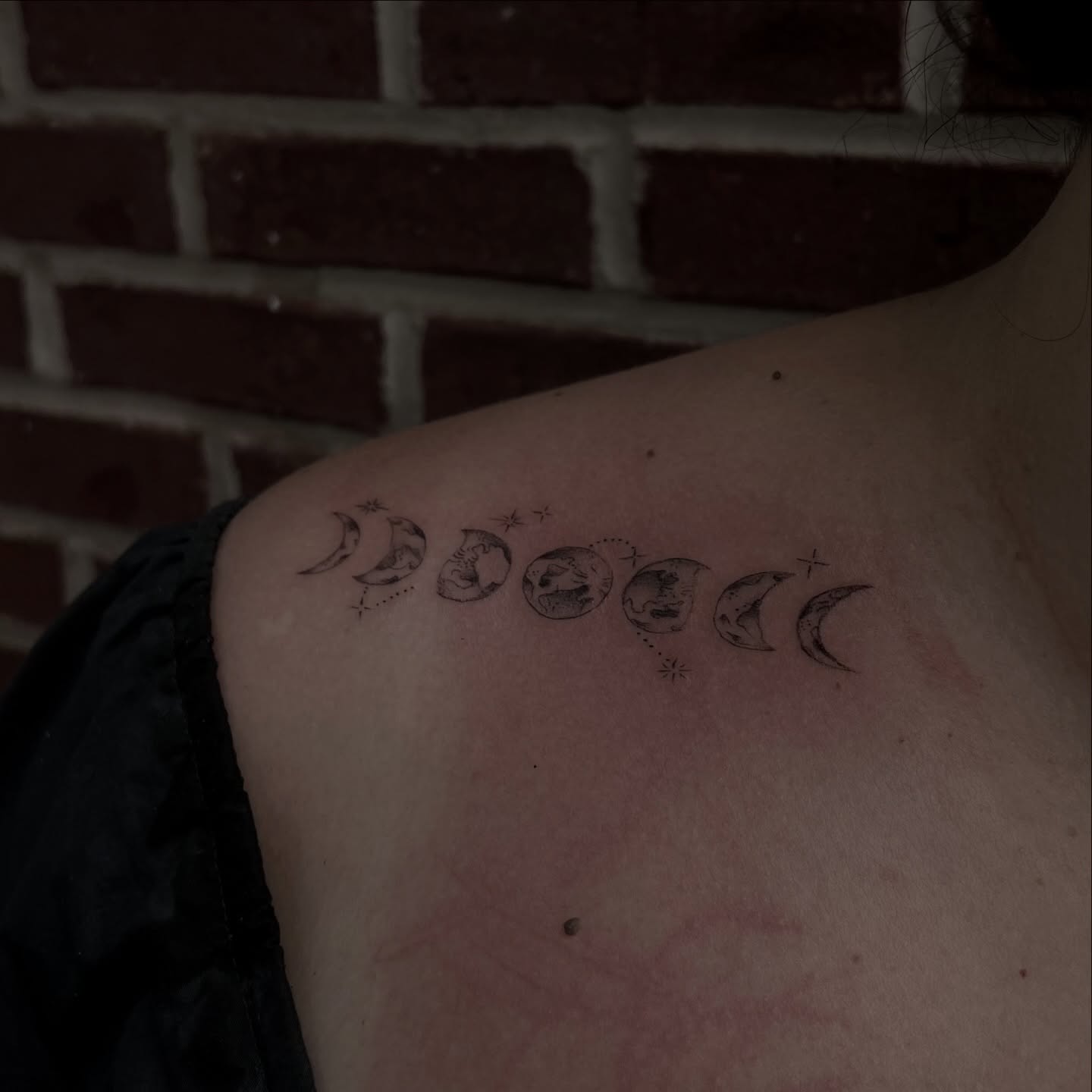 Moon phases black and grey tattoo on the shoulder by ashlyn rene