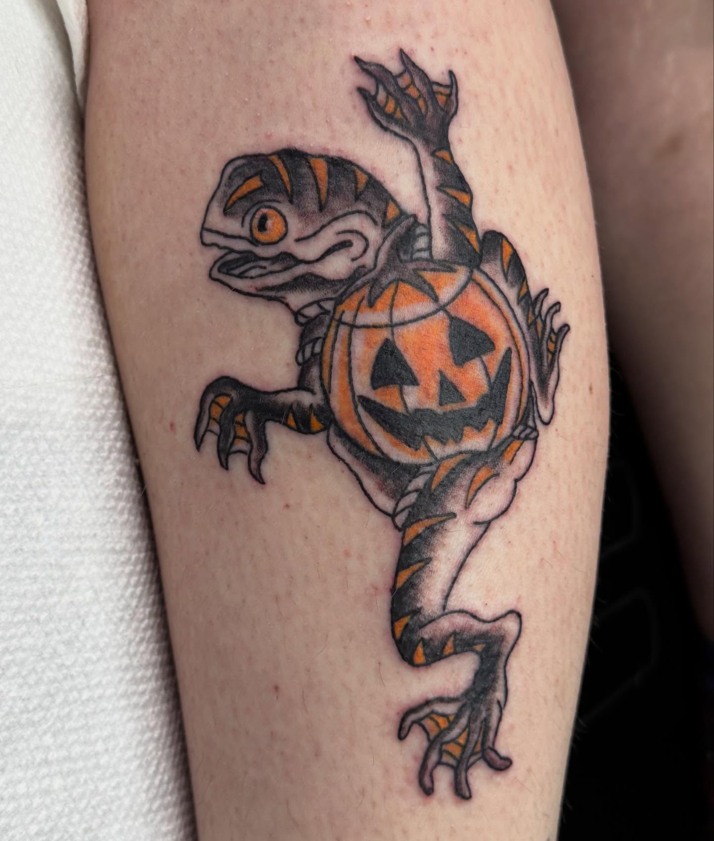 Lizard with pumpkin American traditional tattoo on the forearm by 🌛 𐌀𐌋𐌄𐋄𐌉𐌔 🌜