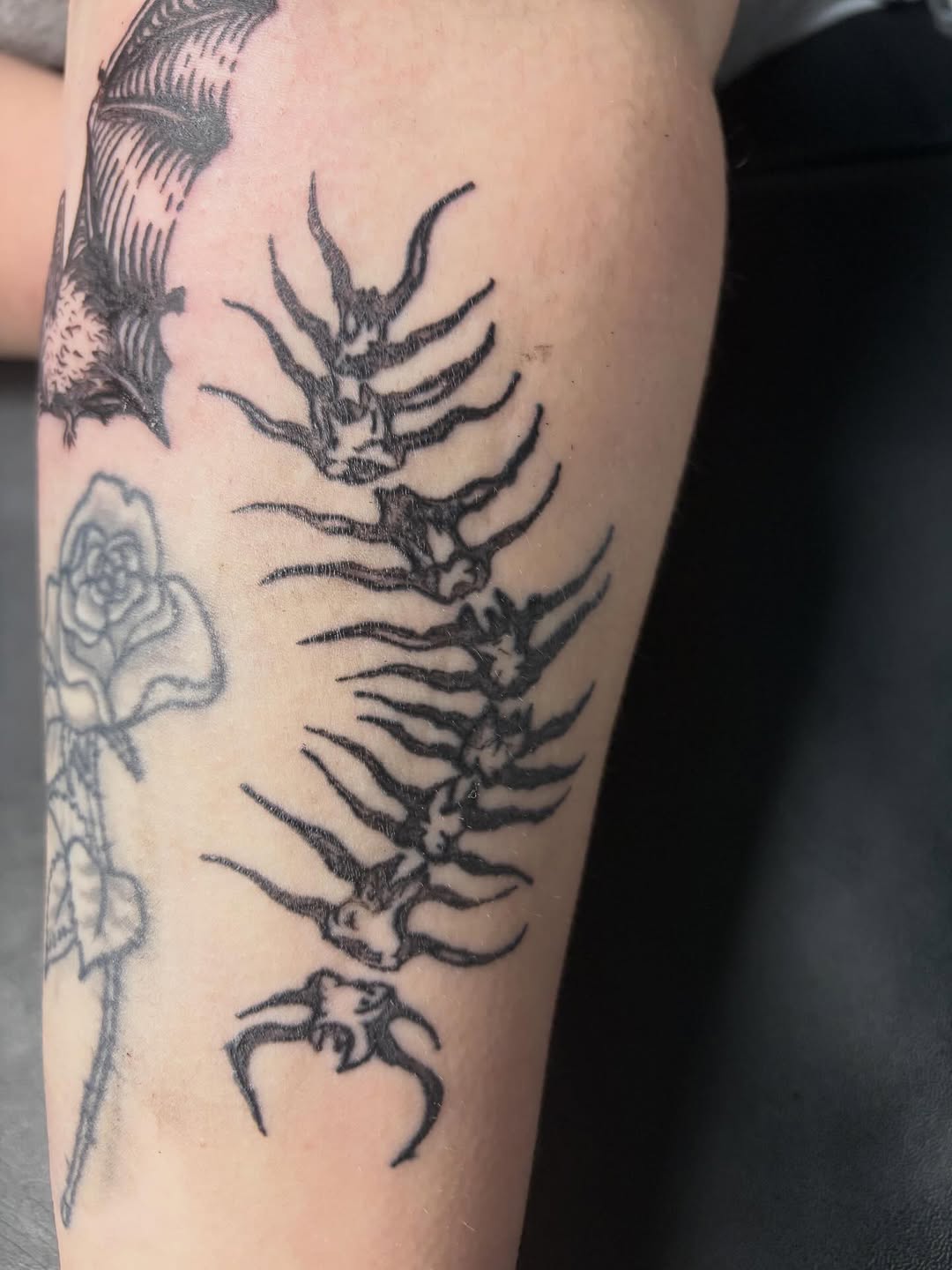 Spine with legs cyber sigilism tattoo on the forearm by Madison