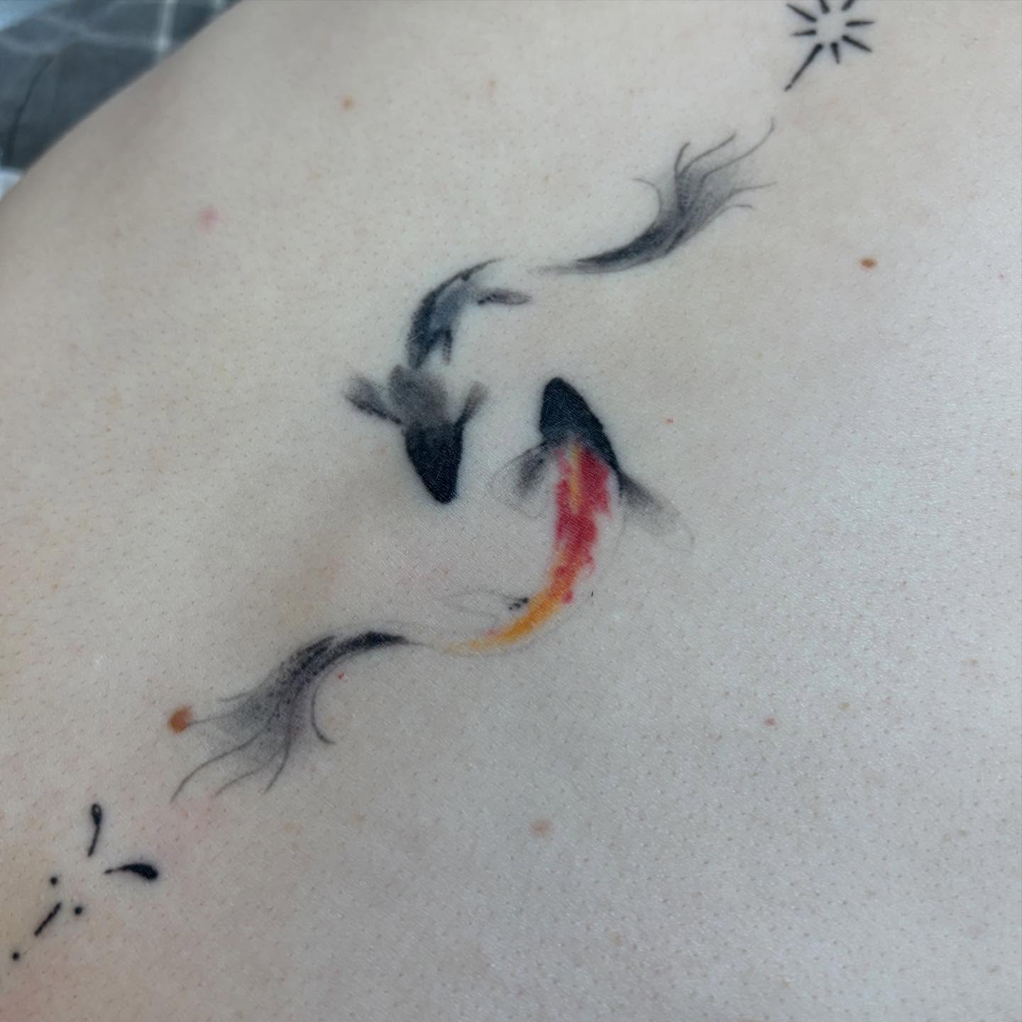 Goldfish watercolor tattoo on the upper arm by dayton skuse, Portland, Oregon